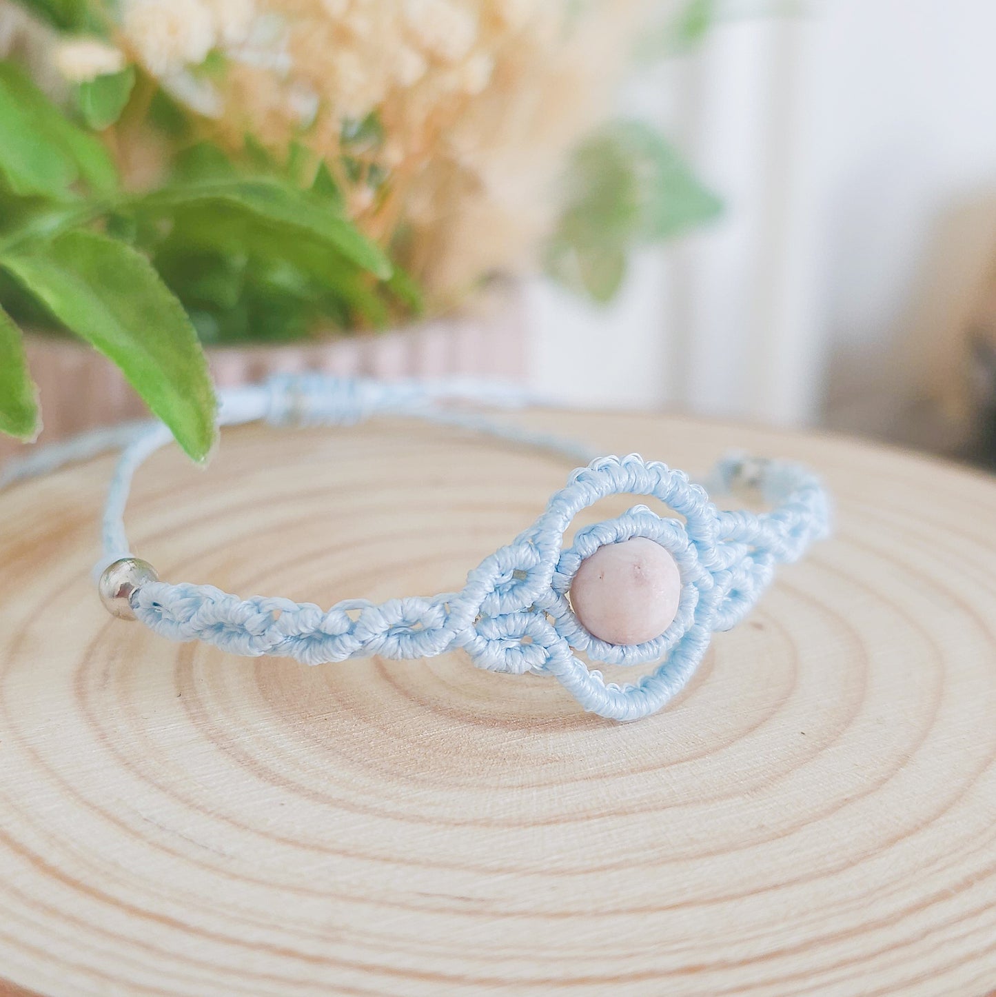 Handmade macrame bracelet with baby blue string and pink zebra Jasper beads, infused with Strawberry Full Moon energy for love and balance