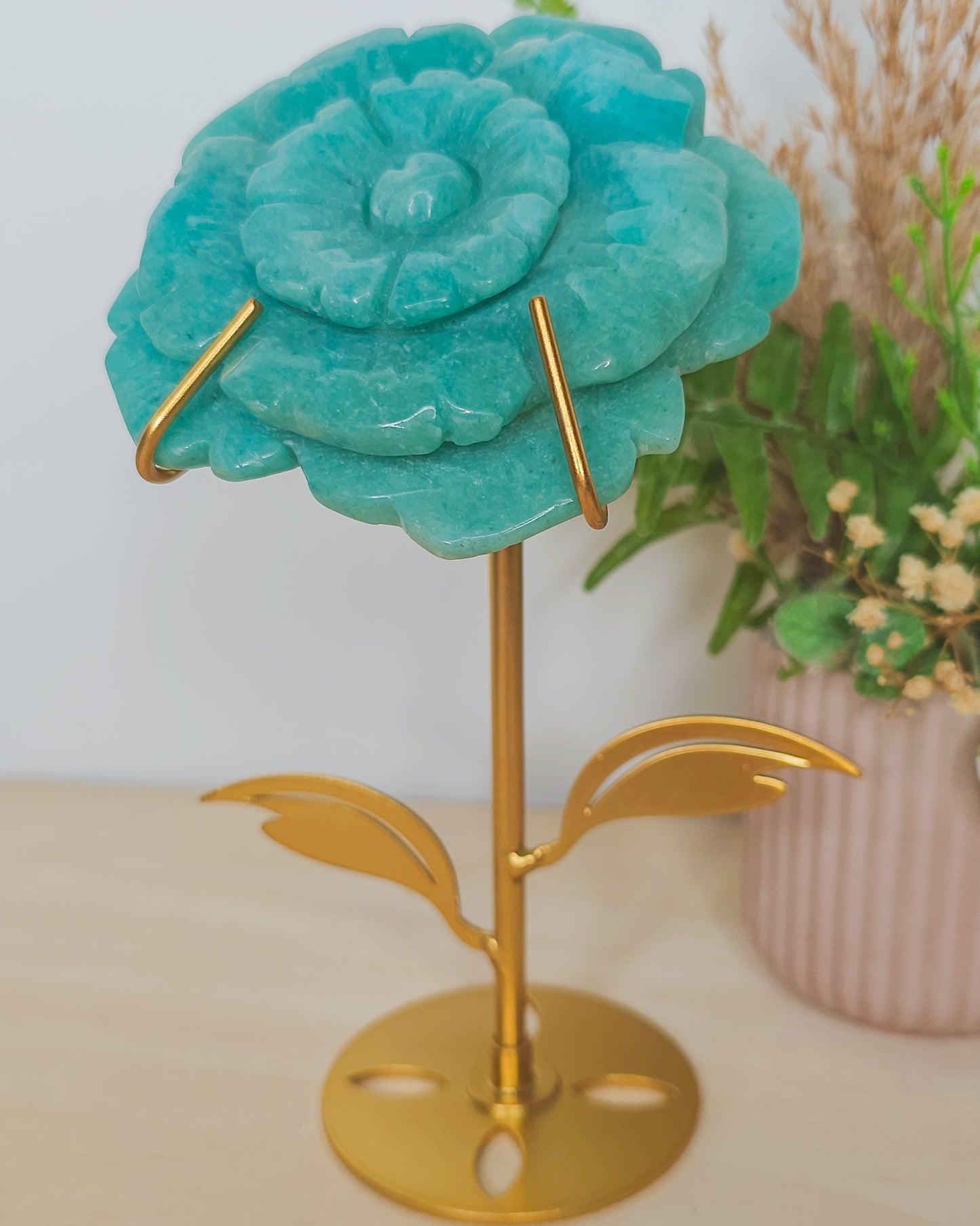 Close-up of Amazonite flower carving, showcasing natural blue-green hues and petal details, symbolizing inner peace and spiritual unfolding.