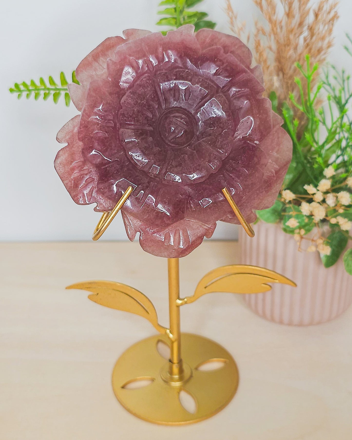 Strawberry Quartz flower crystal on metal stand, soft pink tones with sparkles symbolizing joy, love, and emotional healing.