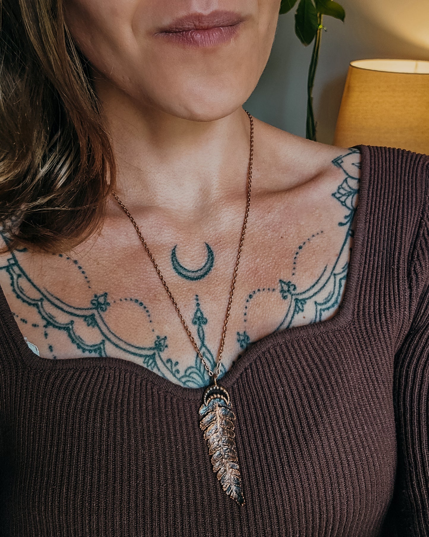 Copper electroformed fern pendant with crescent moon detail worn on a copper-coloured chain, handcrafted from a real fern gathered in Scotland and photographed being worn to show scale and fit.