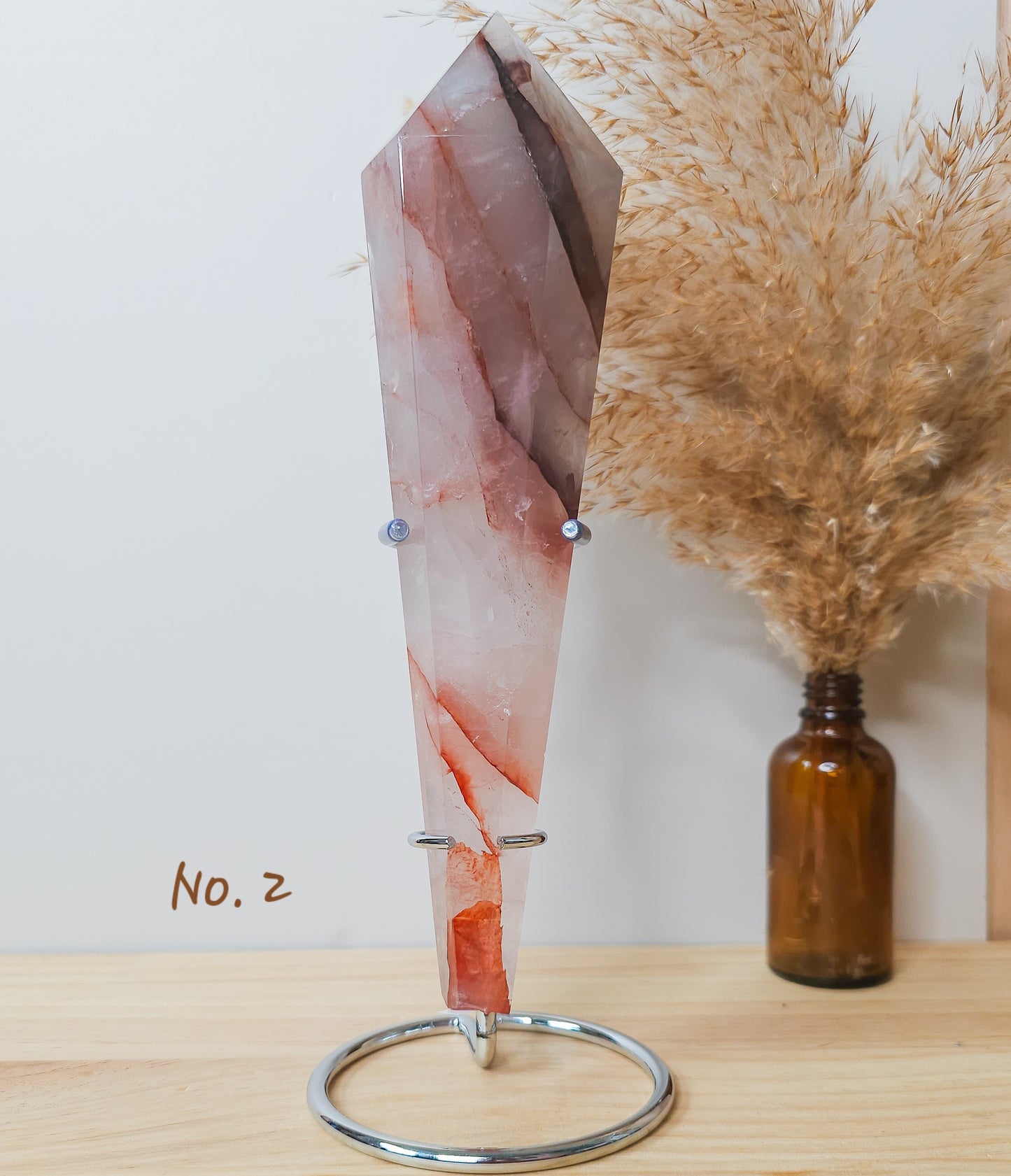 Red Hematoid/Fire Quartz Wand on the stand