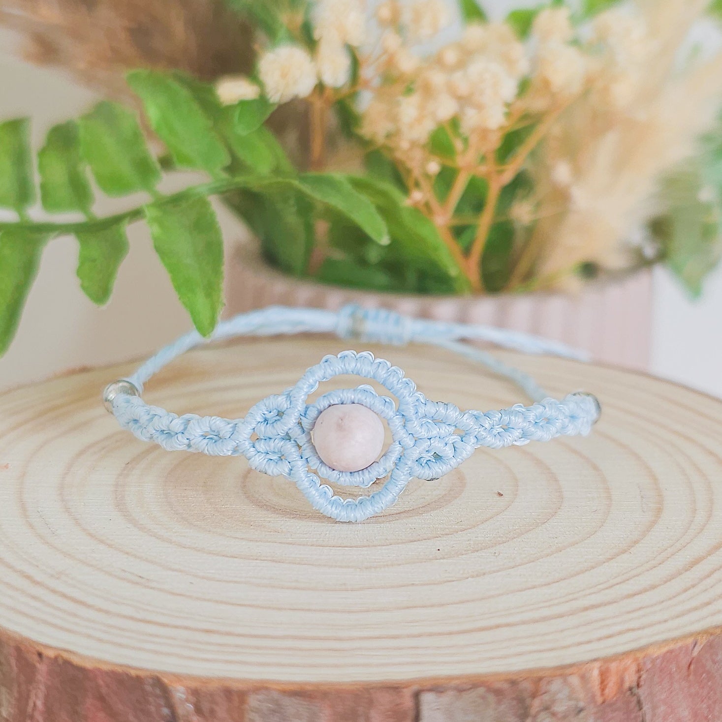 Handmade macrame bracelet with baby blue string and pink zebra Jasper beads, infused with Strawberry Full Moon energy for love and balance