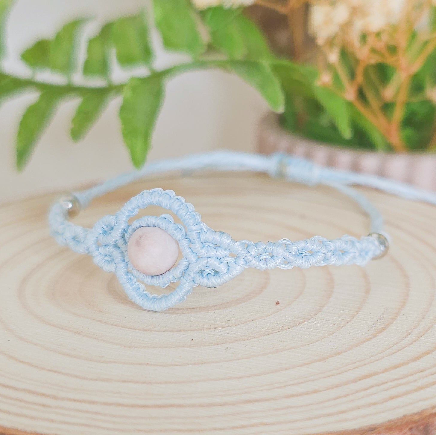Handmade macrame bracelet with baby blue string and pink zebra Jasper beads, infused with Strawberry Full Moon energy for love and balance