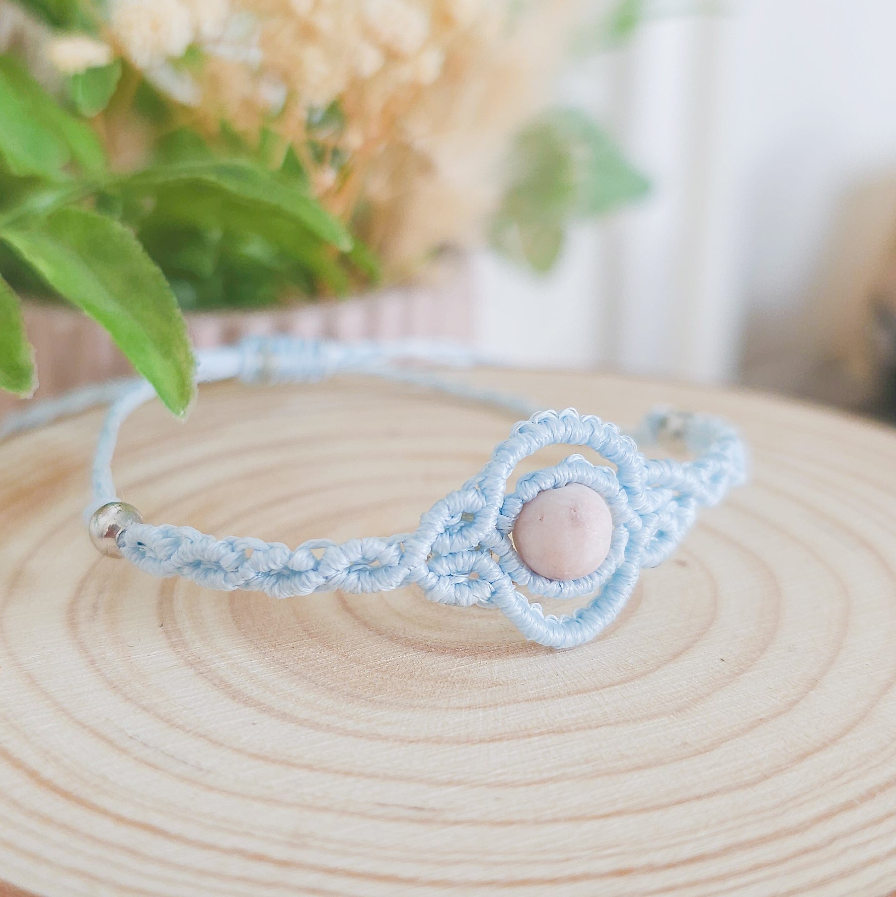 Handmade macrame bracelet with baby blue string and pink zebra Jasper beads, infused with Strawberry Full Moon energy for love and balance