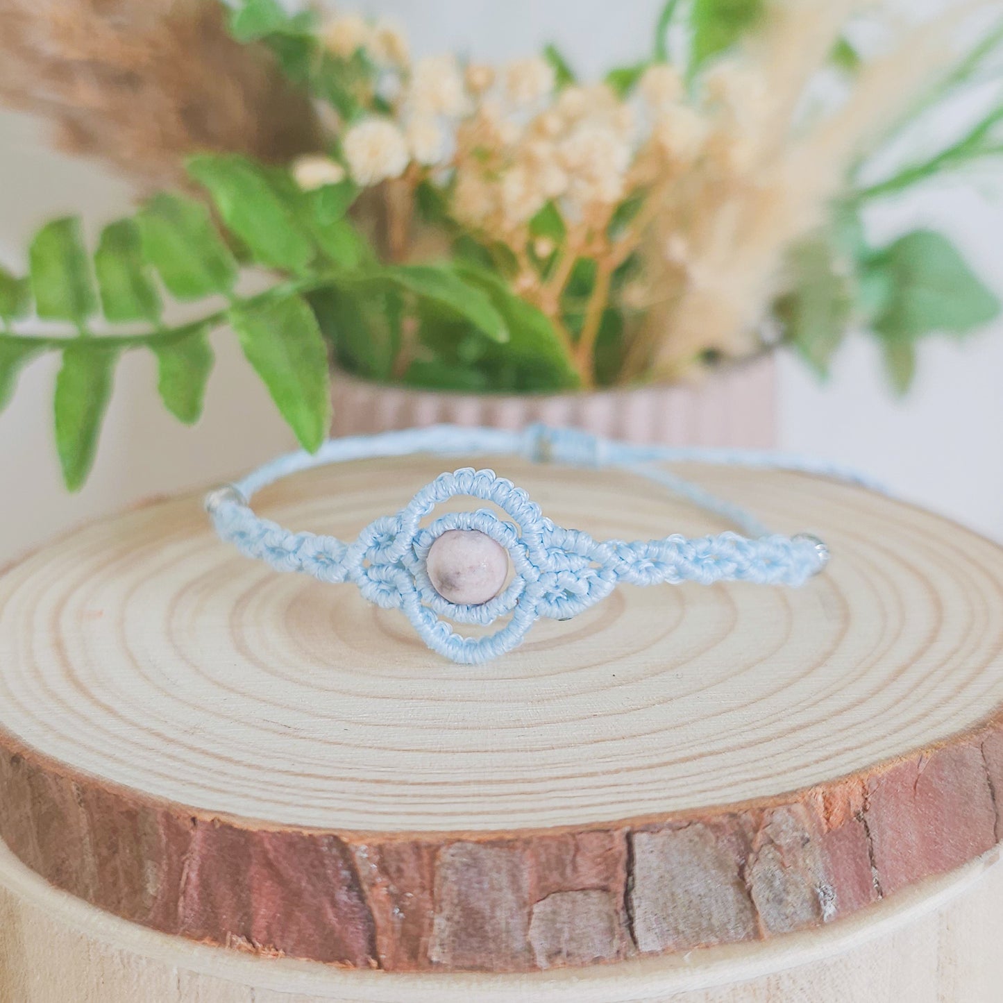 Handmade macrame bracelet with baby blue string and pink zebra Jasper beads, infused with Strawberry Full Moon energy for love and balance