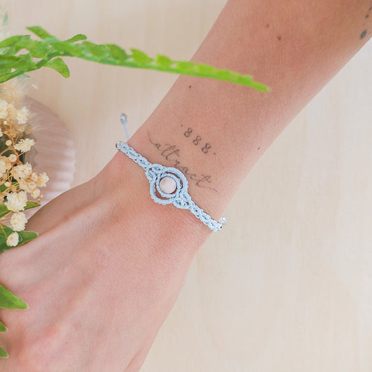 Handmade macrame bracelet with baby blue string and pink zebra Jasper beads, infused with Strawberry Full Moon energy for love and balance