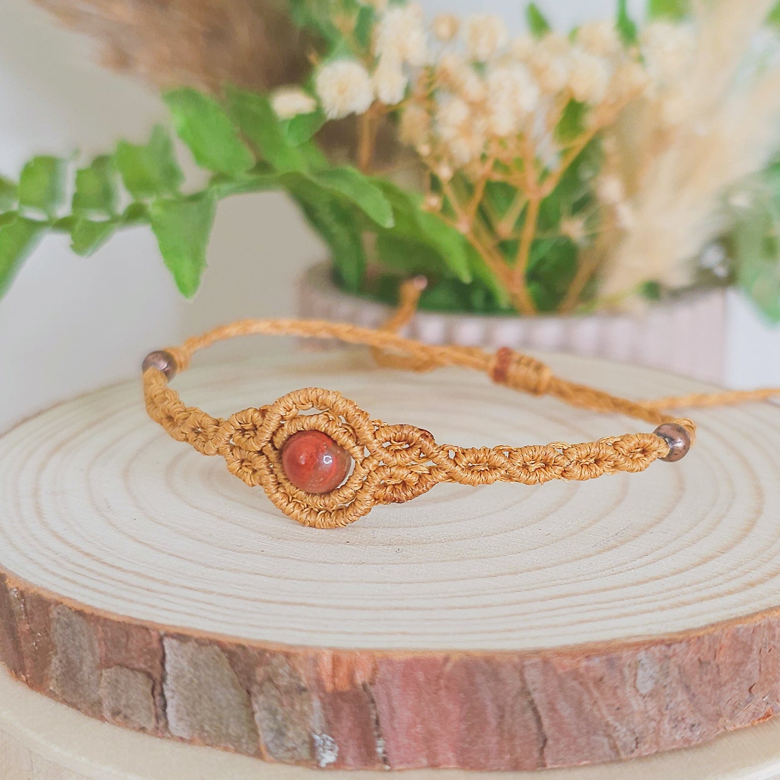 Handmade macrame bracelet with Red Jasper beads, infused with Strawberry Full Moon energy for strength, grounding, and emotional clarity