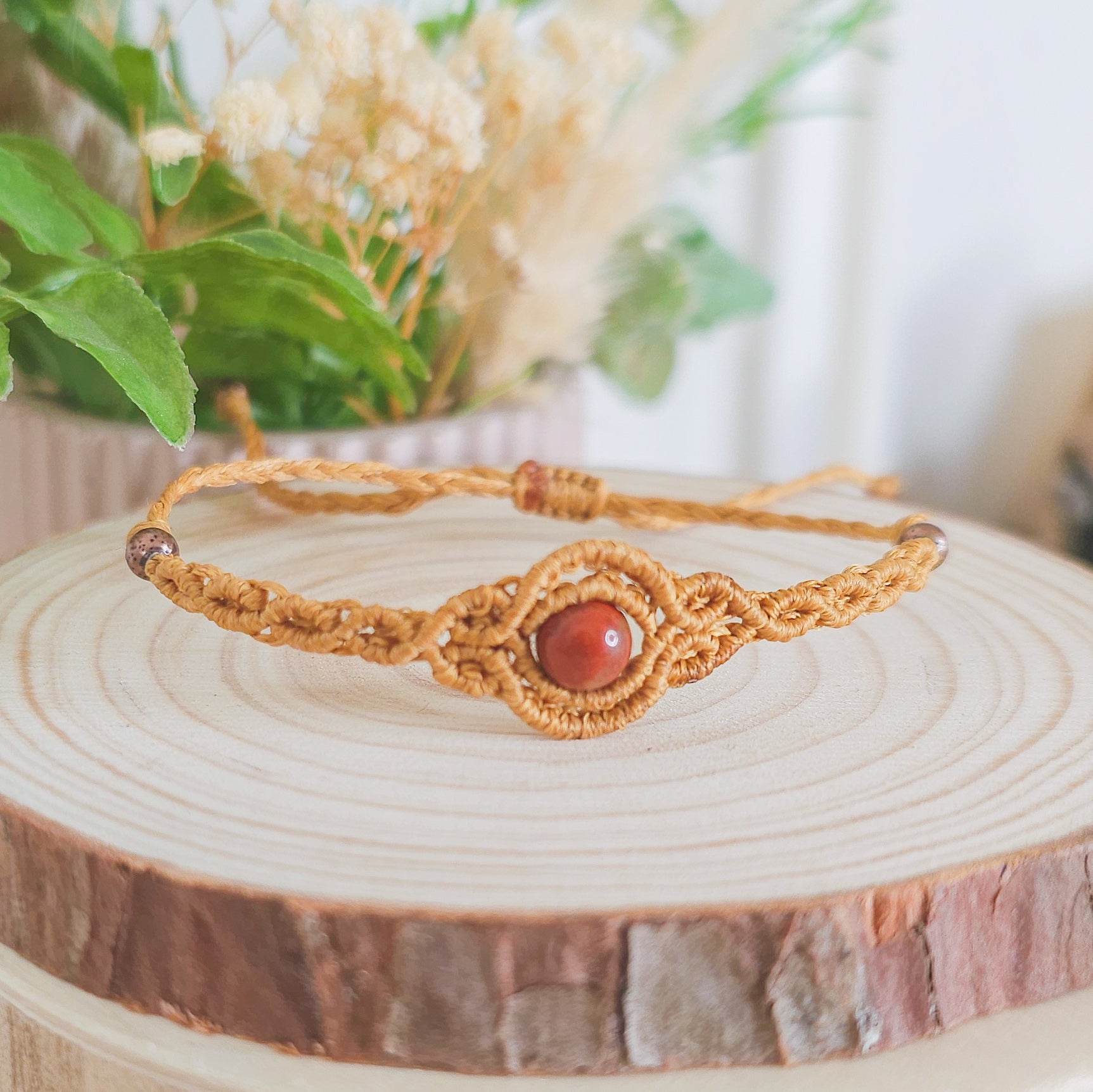 Handmade macrame bracelet with Red Jasper beads, infused with Strawberry Full Moon energy for strength, grounding, and emotional clarity