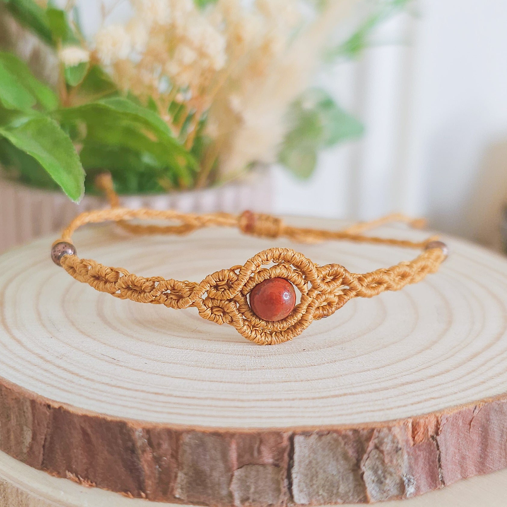 Handmade macrame bracelet with Red Jasper beads, infused with Strawberry Full Moon energy for strength, grounding, and emotional clarity
