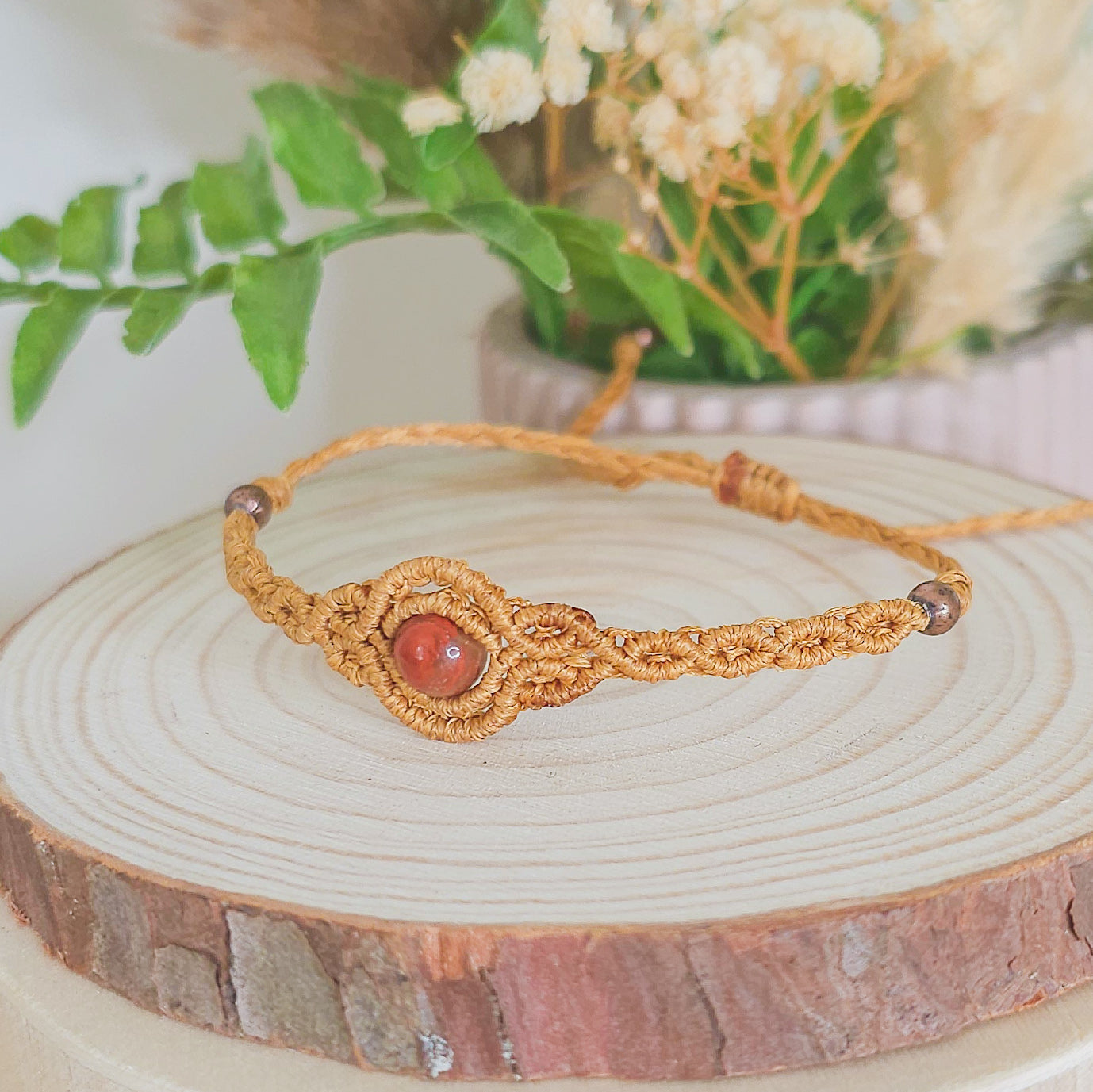 Handmade macrame bracelet with Red Jasper beads, infused with Strawberry Full Moon energy for strength, grounding, and emotional clarity