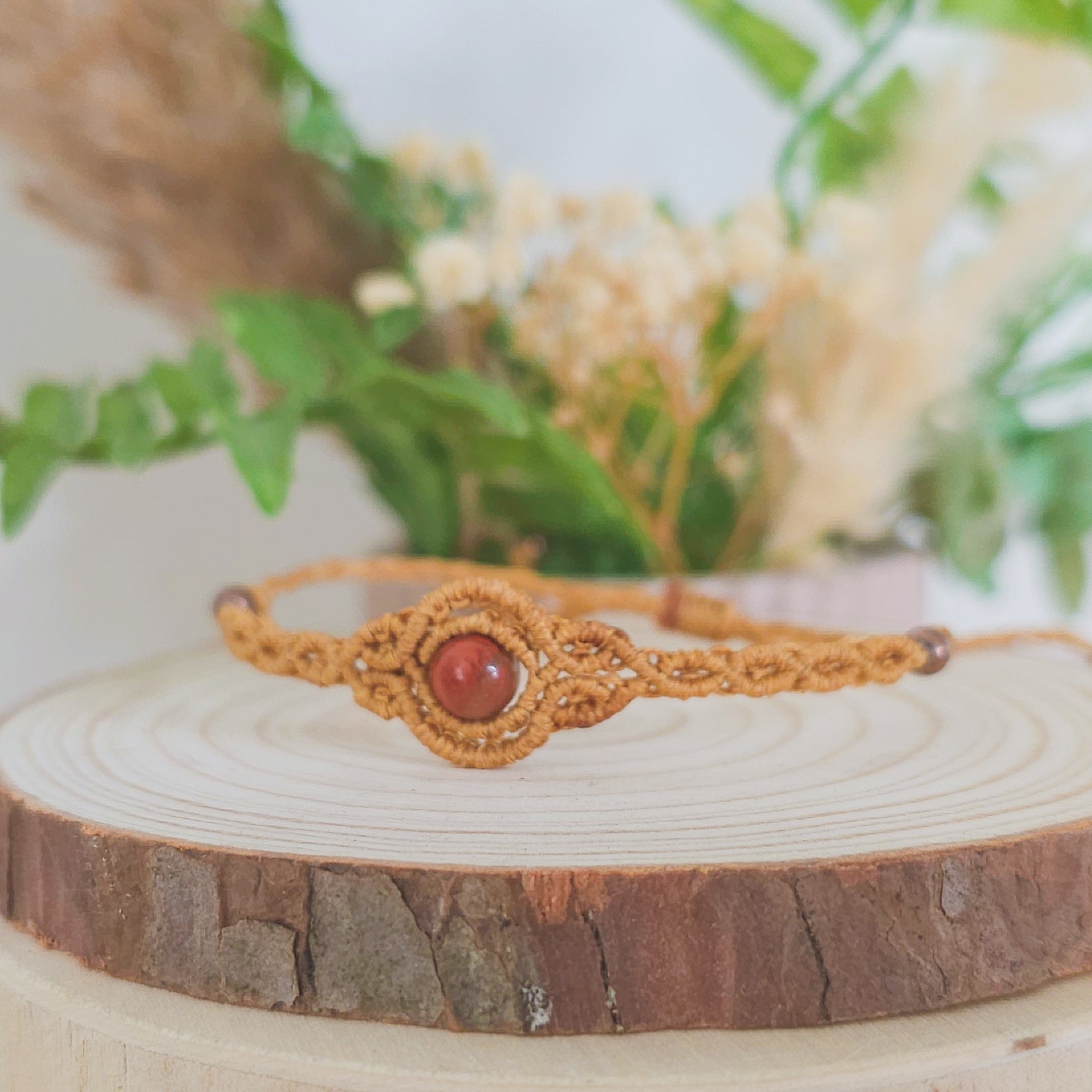 Handmade macrame bracelet with Red Jasper beads, infused with Strawberry Full Moon energy for strength, grounding, and emotional clarity