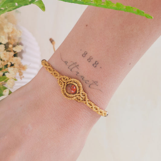 Handmade macrame bracelet with Red Jasper beads, infused with Strawberry Full Moon energy for strength, grounding, and emotional clarity