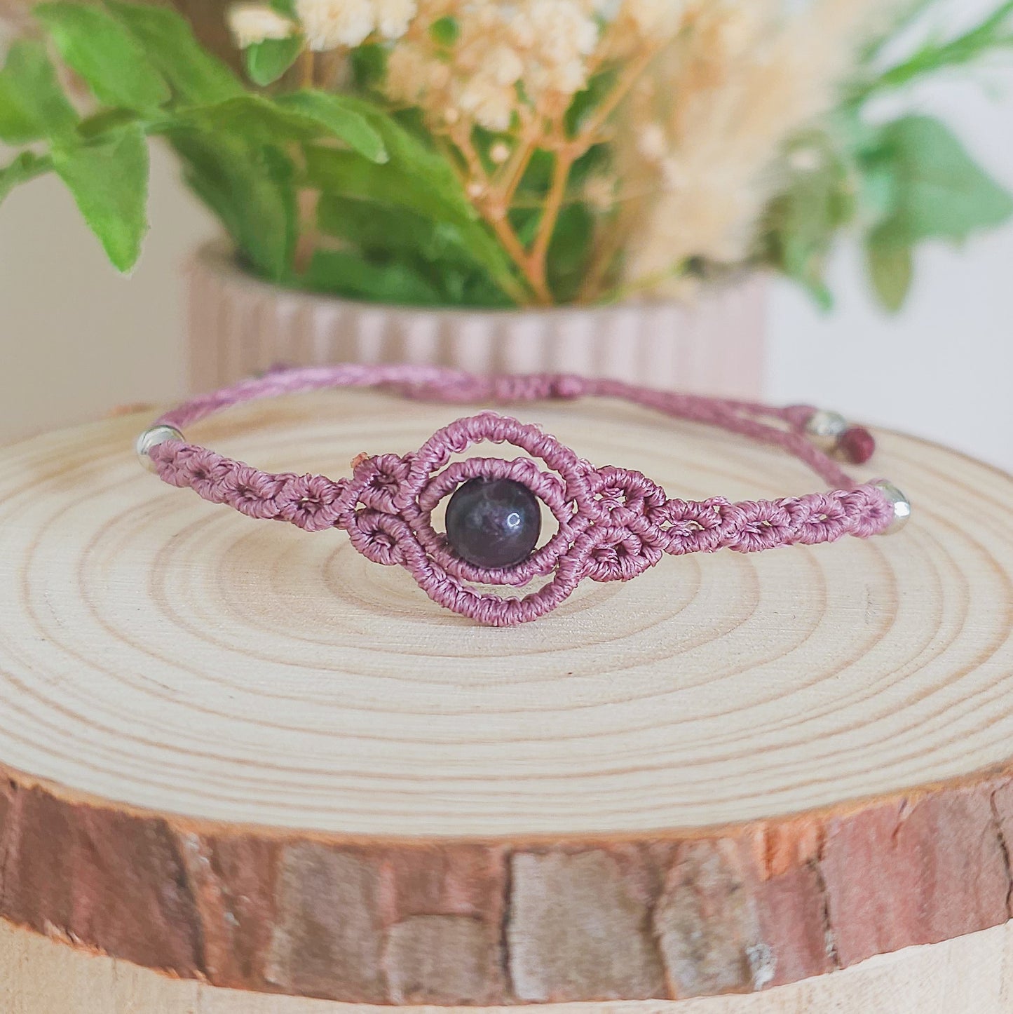 Handmade macrame bracelet with purple Fluorite beads, infused with Strawberry Full Moon energy for clarity, intuition, and emotional balance