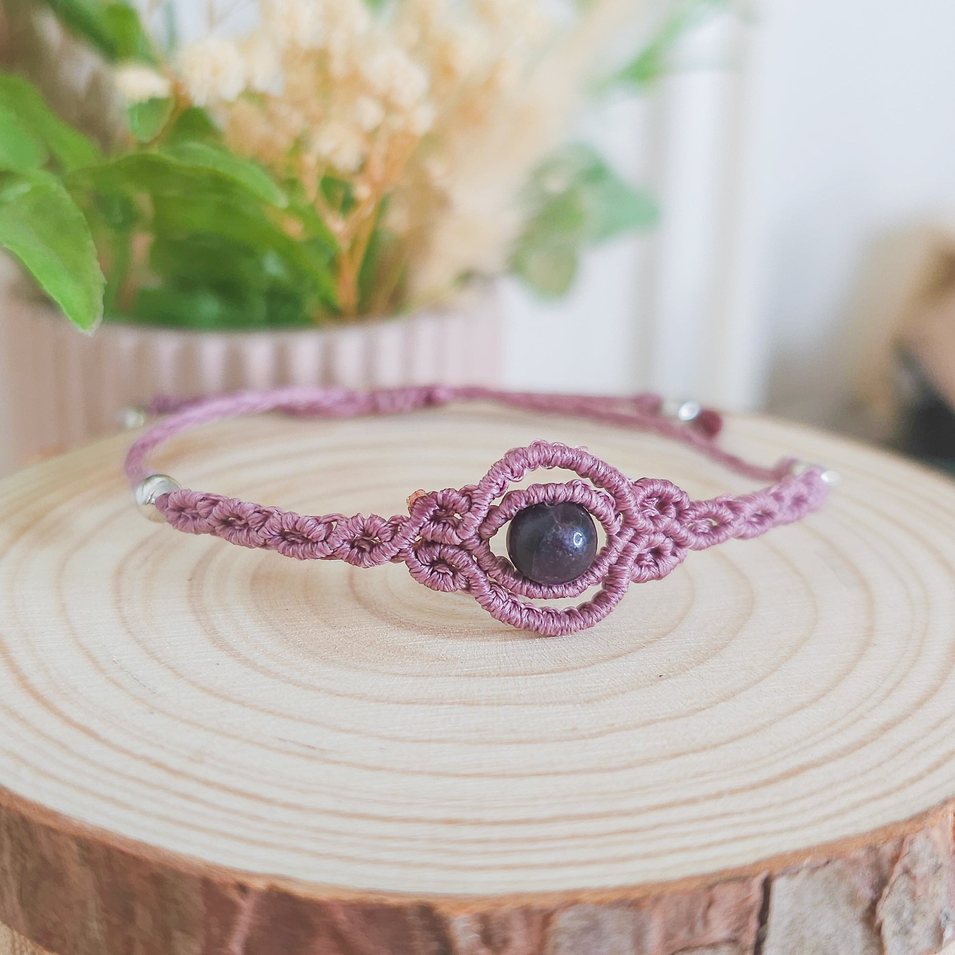 Handmade macrame bracelet with purple Fluorite beads, infused with Strawberry Full Moon energy for clarity, intuition, and emotional balance