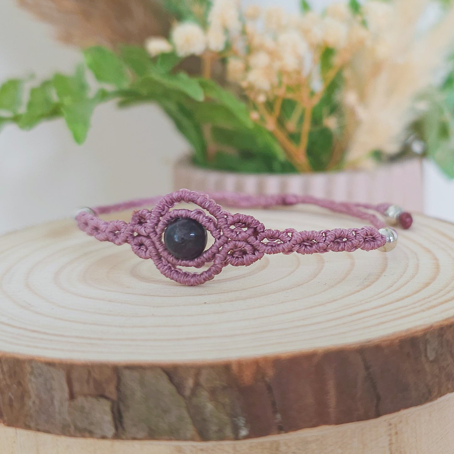 Handmade macrame bracelet with purple Fluorite beads, infused with Strawberry Full Moon energy for clarity, intuition, and emotional balance