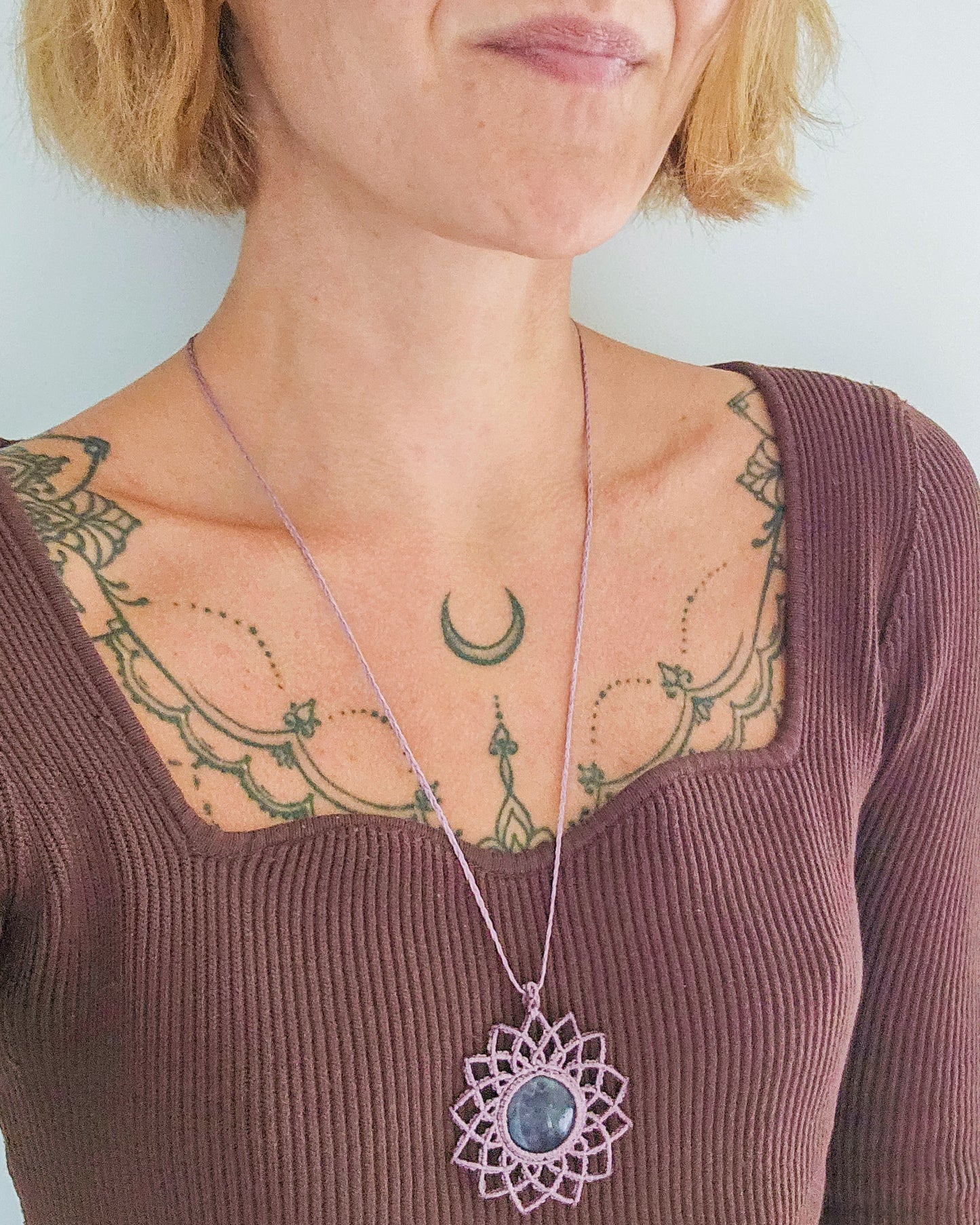 Handwoven mandala necklace featuring a natural Amethyst crystal, symbolizing intuition, spiritual wisdom, and inner vision.
