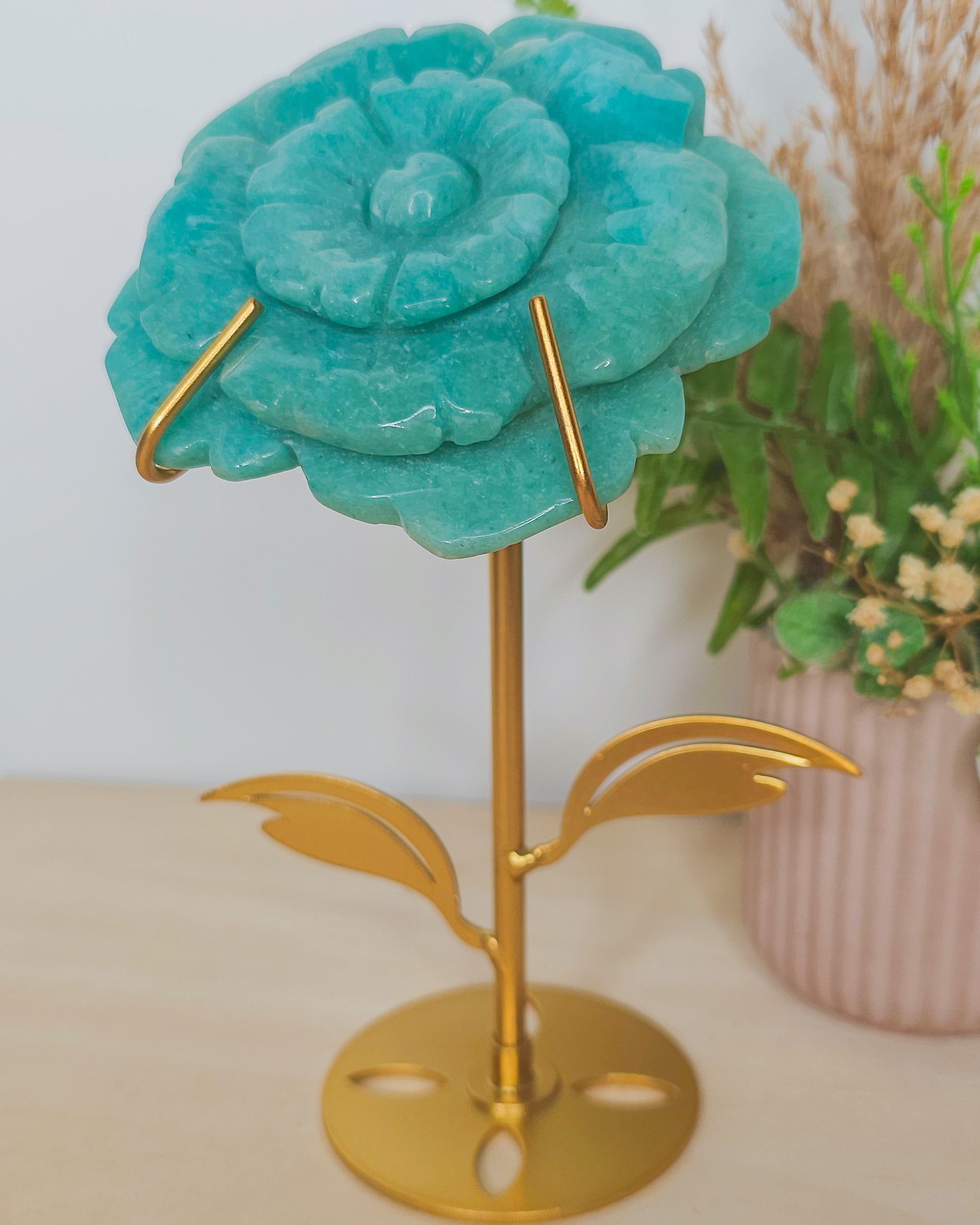 Close-up of Amazonite flower carving, showcasing natural blue-green hues and petal details, symbolizing inner peace and spiritual unfolding.