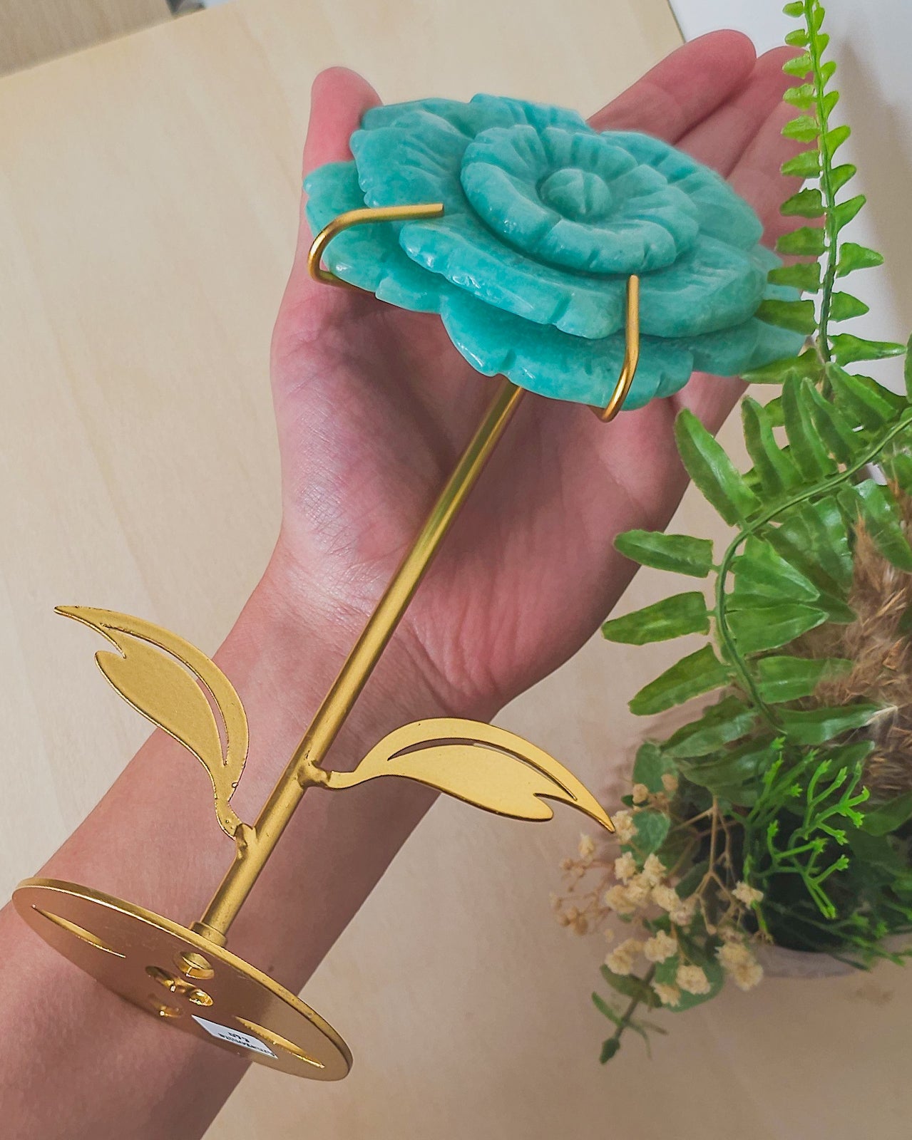 Close-up of Amazonite flower carving, showcasing natural blue-green hues and petal details, symbolizing inner peace and spiritual unfolding.