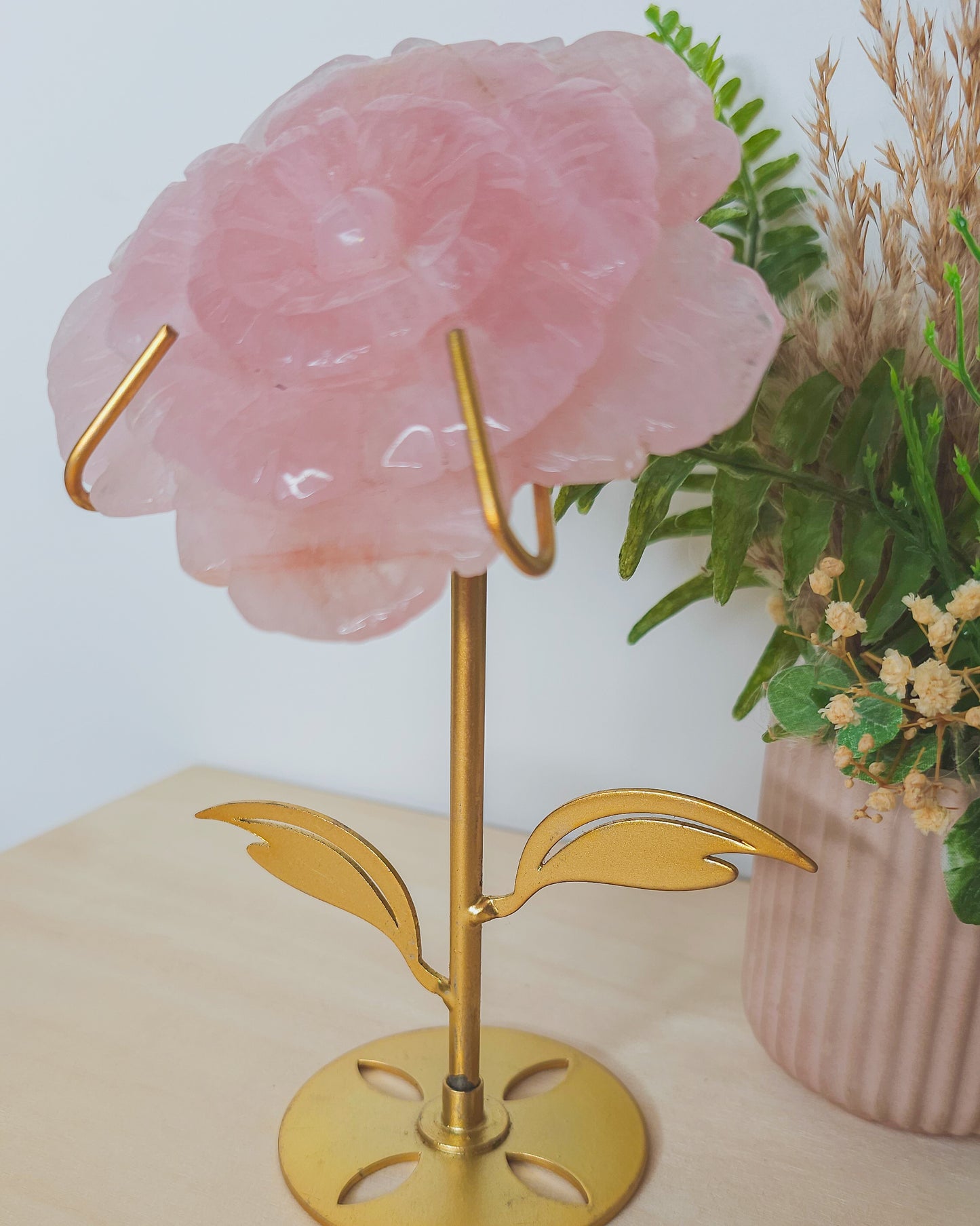  Rose Quartz flower crystal on metal stand, soft pink hues symbolizing unconditional love, heart healing, and emotional balance.

