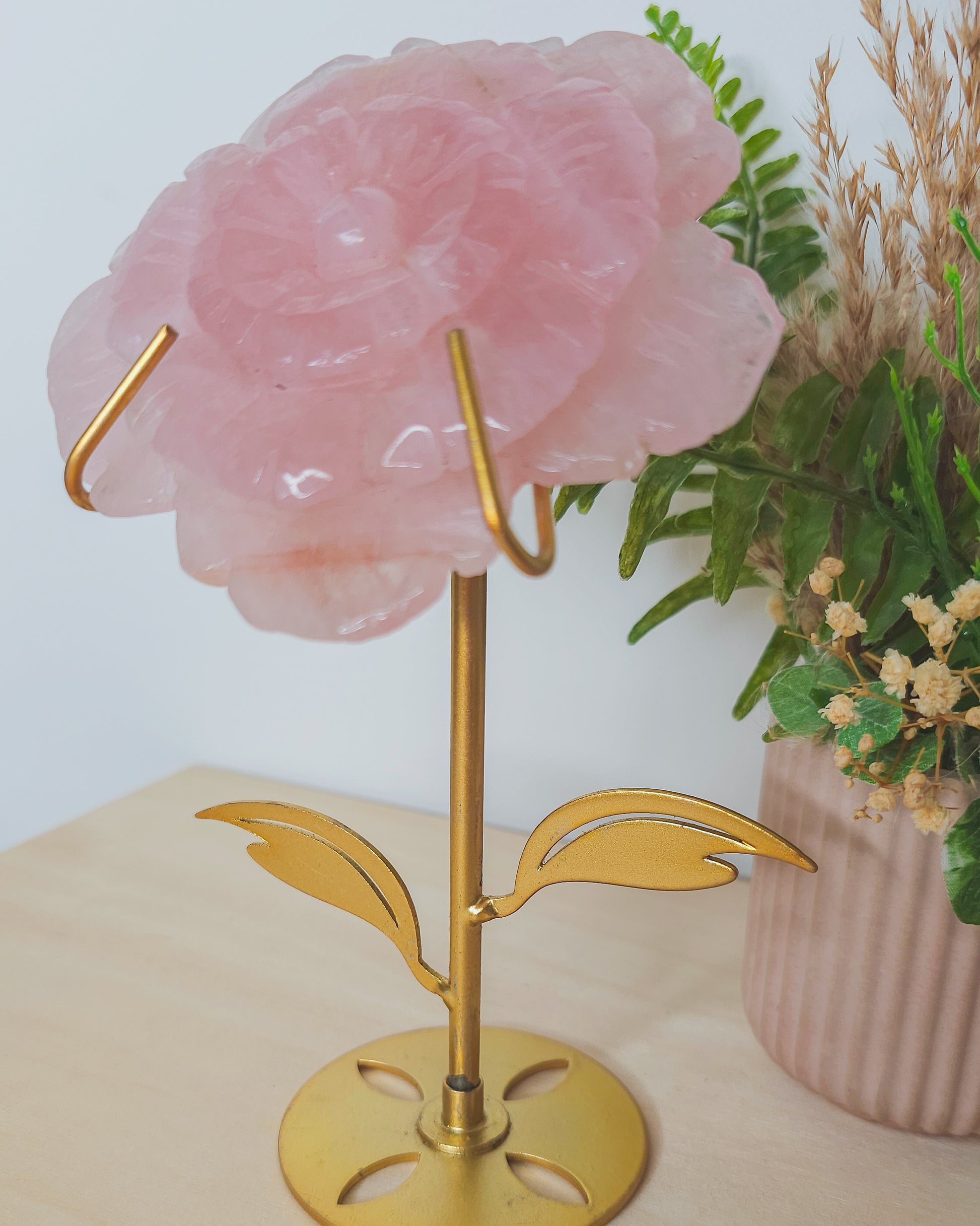  Rose Quartz flower crystal on metal stand, soft pink hues symbolizing unconditional love, heart healing, and emotional balance.
