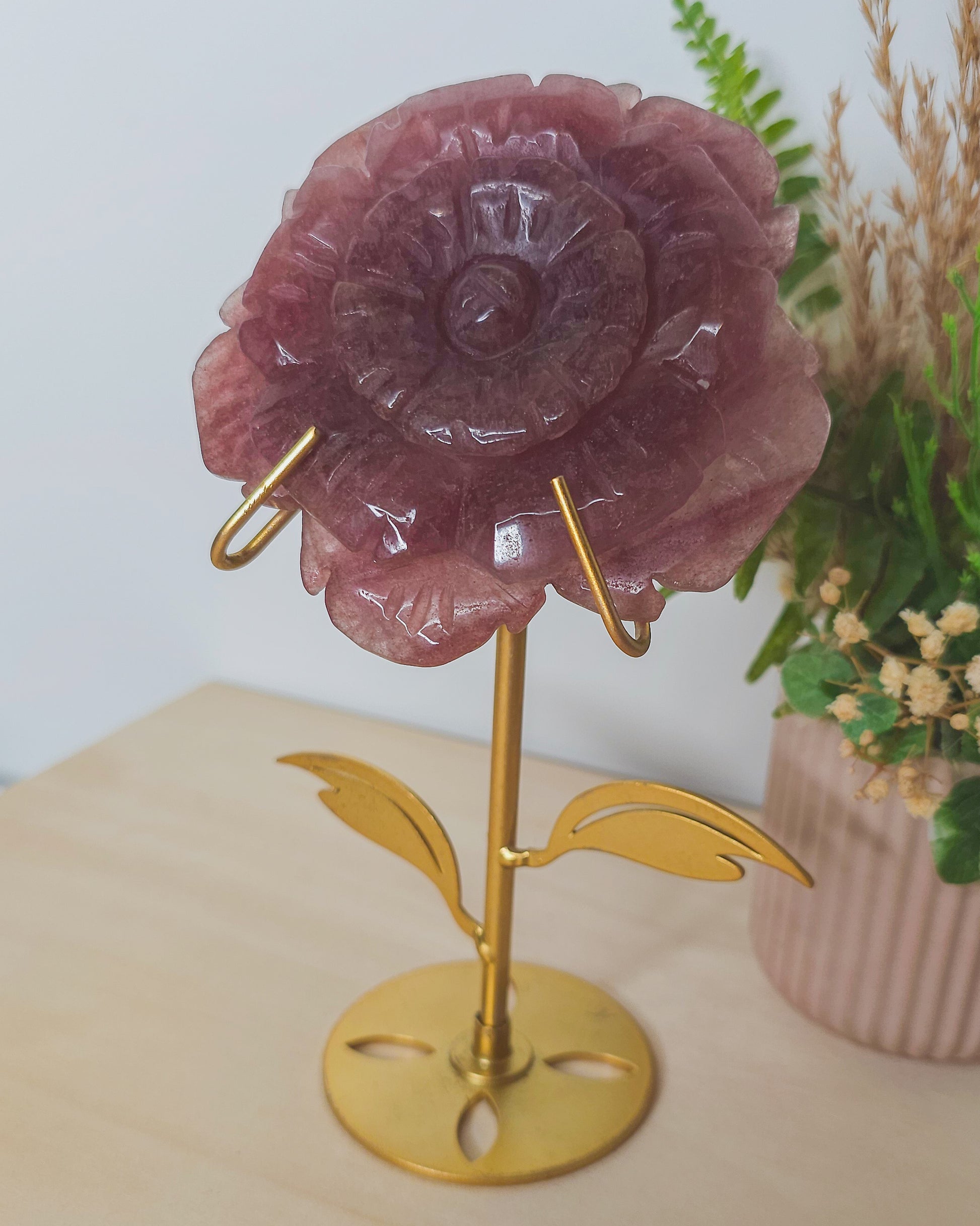 Strawberry Quartz flower carving in warm pink shades with red flecks, symbolizing self-love, vitality, and gentle emotional healing.