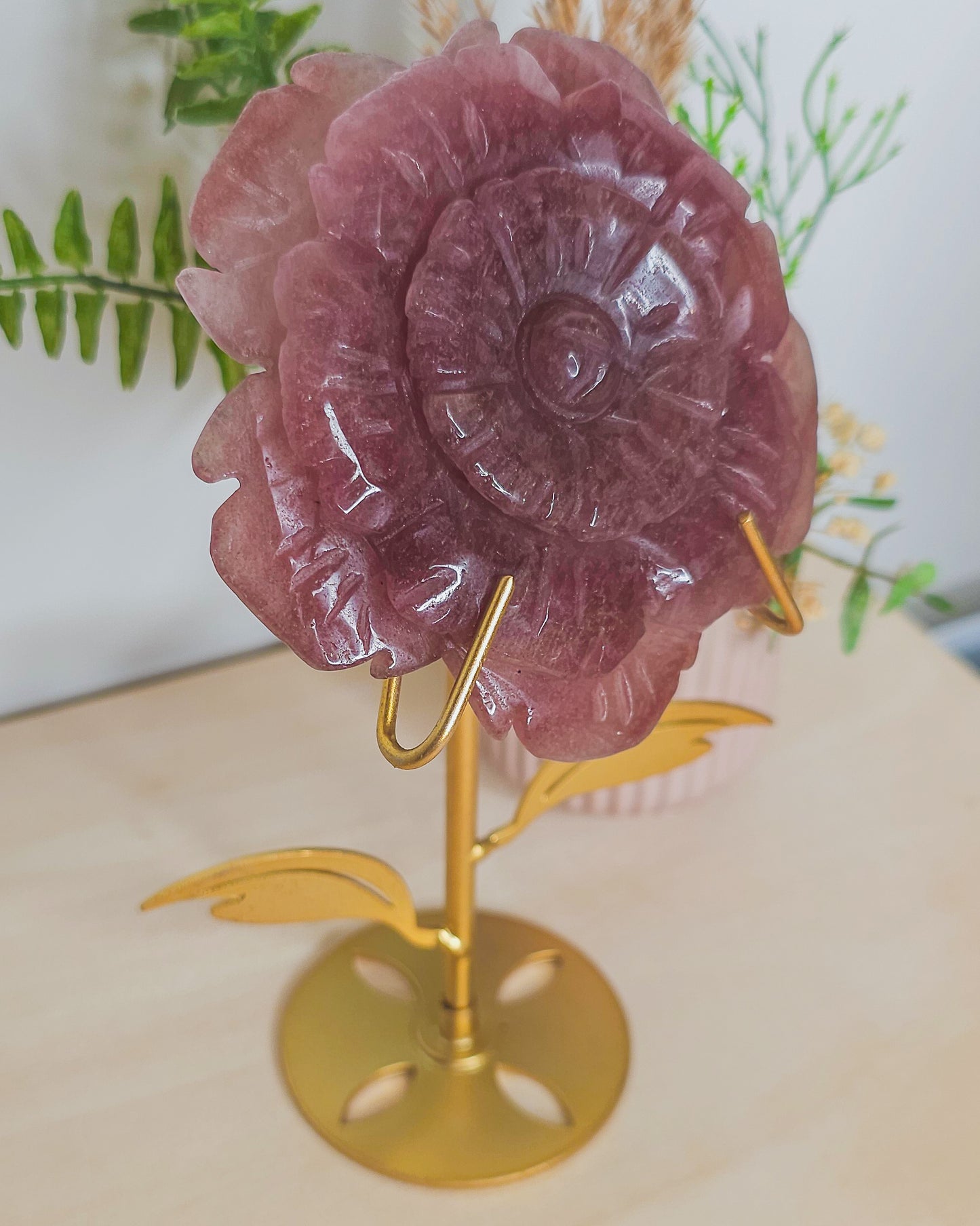 Strawberry Quartz flower crystal on metal stand, soft pink tones with sparkles symbolizing joy, love, and emotional healing.