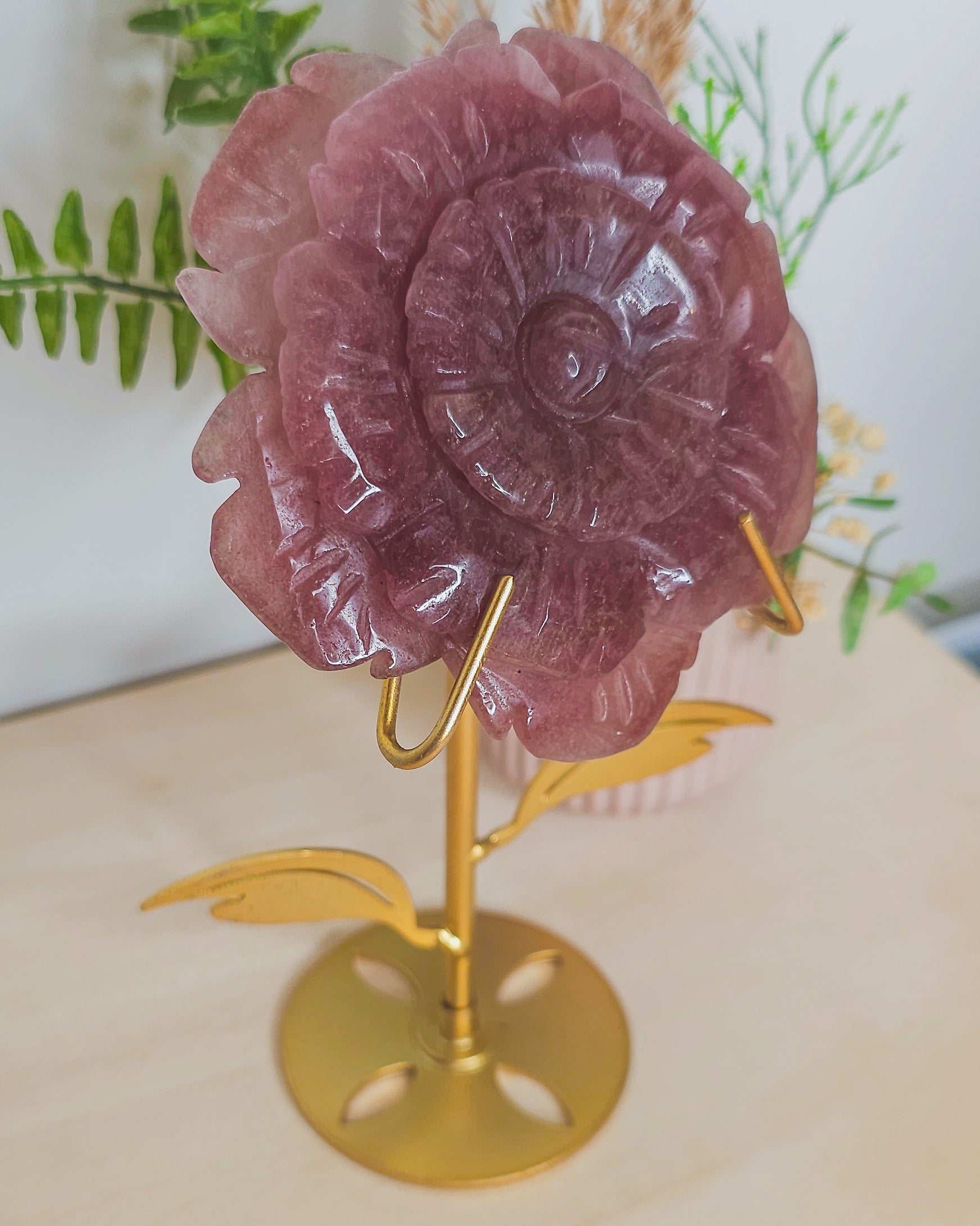 Strawberry Quartz flower crystal on metal stand, soft pink tones with sparkles symbolizing joy, love, and emotional healing.