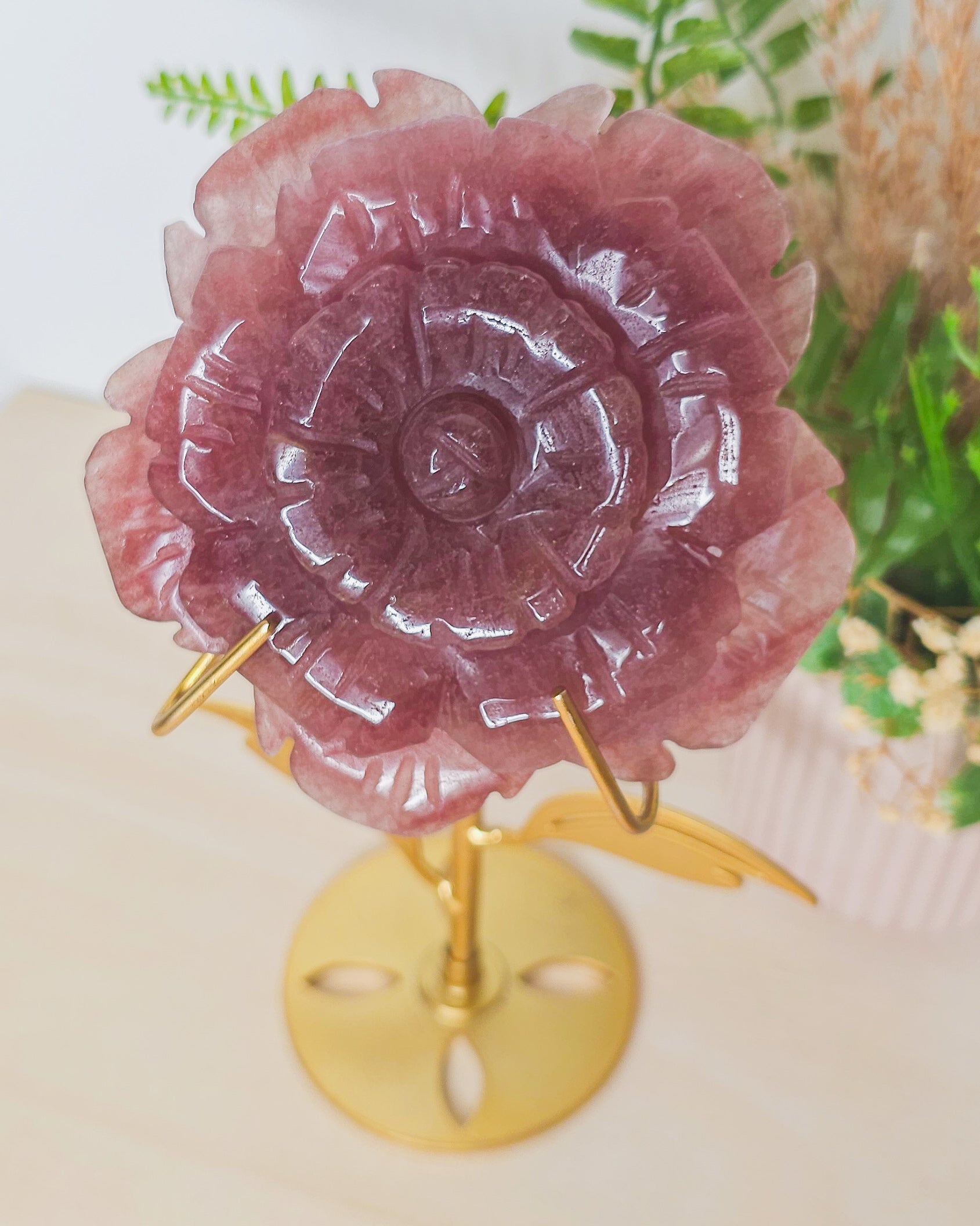 Strawberry Quartz flower carving in warm pink shades with red flecks, symbolizing self-love, vitality, and gentle emotional healing.