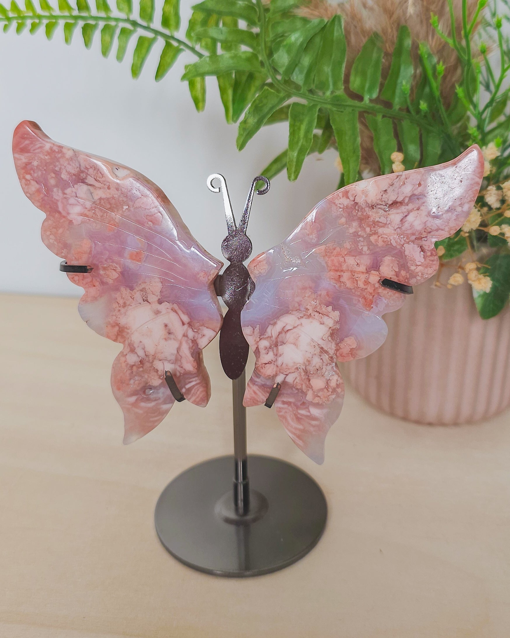  view of the Cotton Candy Agate wings on stand, showcasing the natural patterns and symmetrical shape of the carved wings