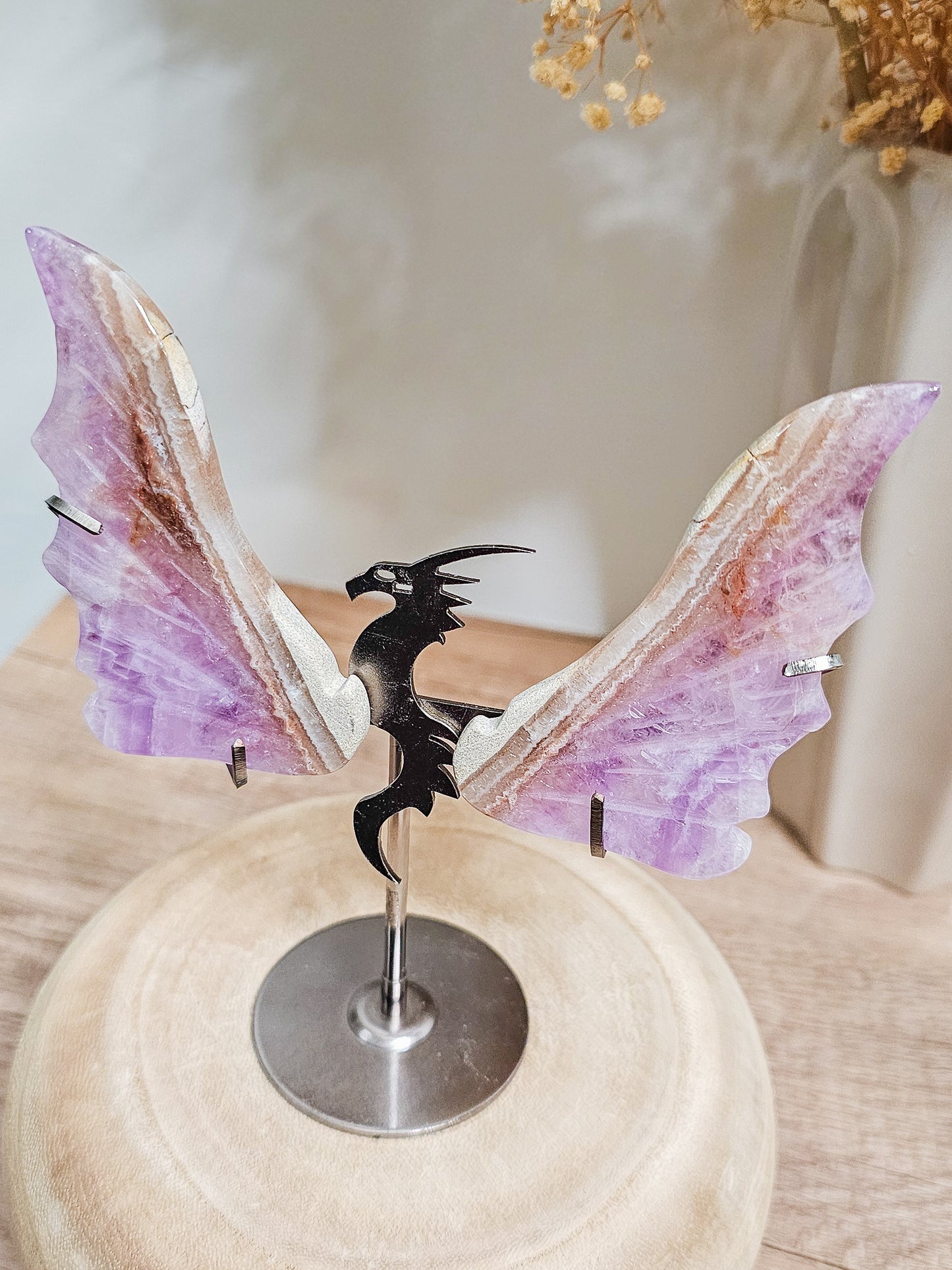 Close-up of carved amethyst dragon wings, highlighting natural crystal patterns and wing shape