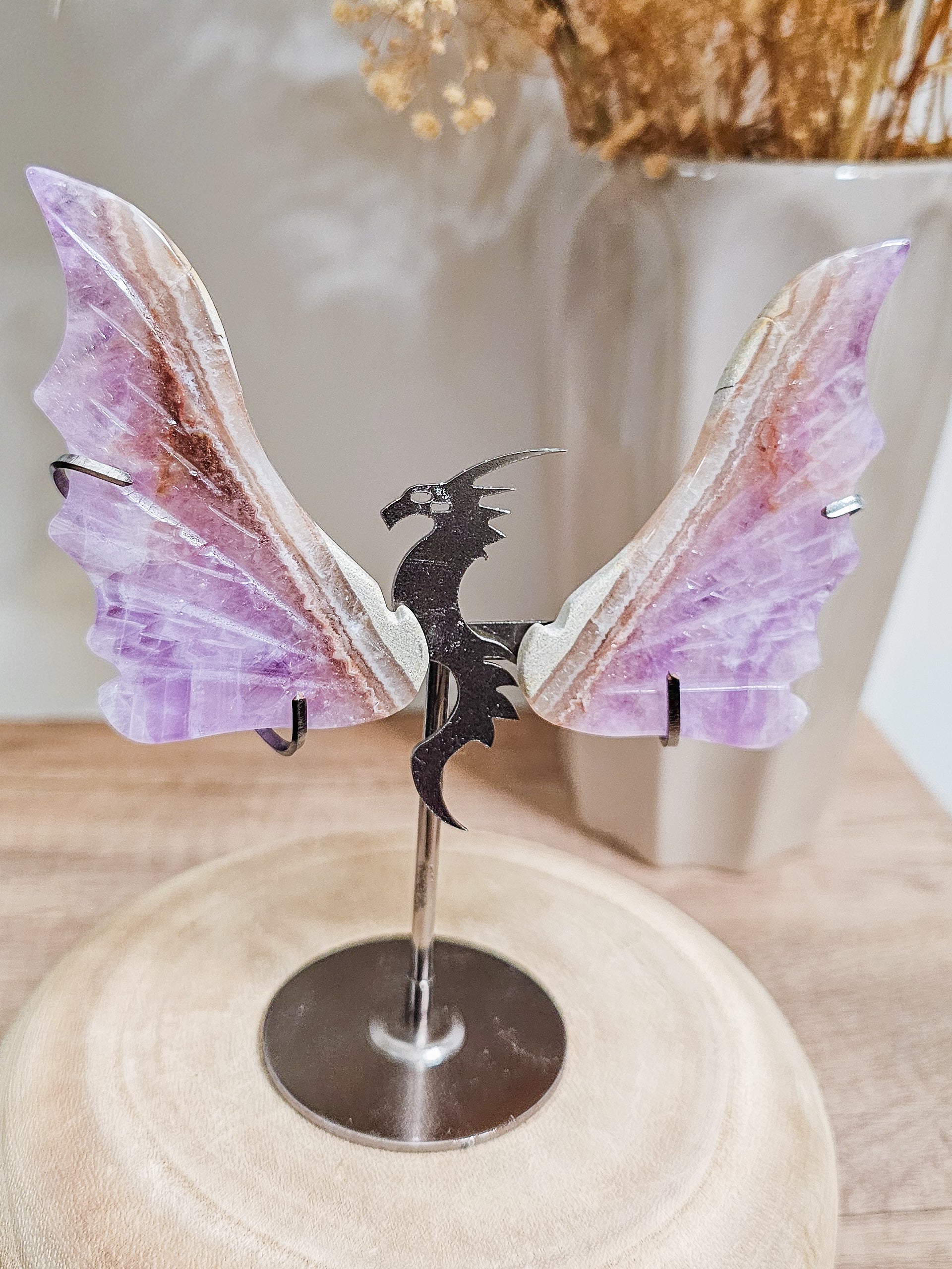 Amethyst dragon wings sculpture on stand, carved crystal with rich purple tones and translucent details