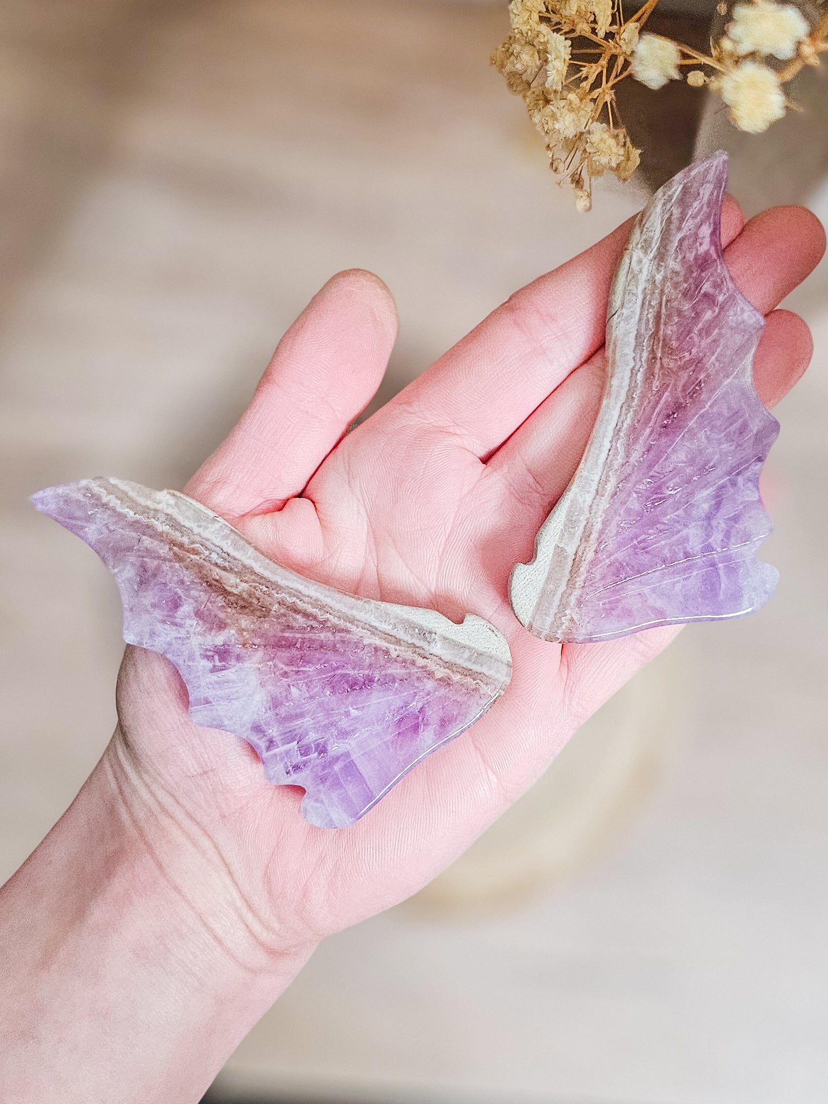 Close-up of carved amethyst dragon Close-up of carved amethyst dragon wings, highlighting natural crystal patterns and wing shape