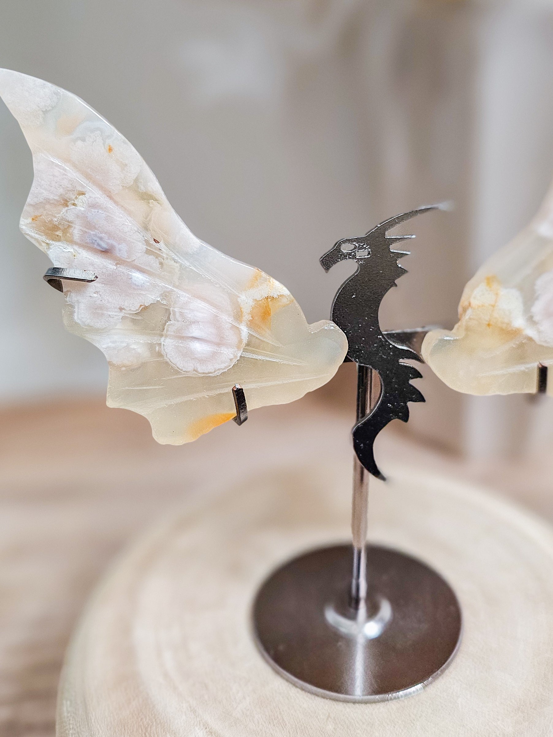 Fluorescent Flower Agate dragon wings sculpture on stand, highlighting natural floral patterns 