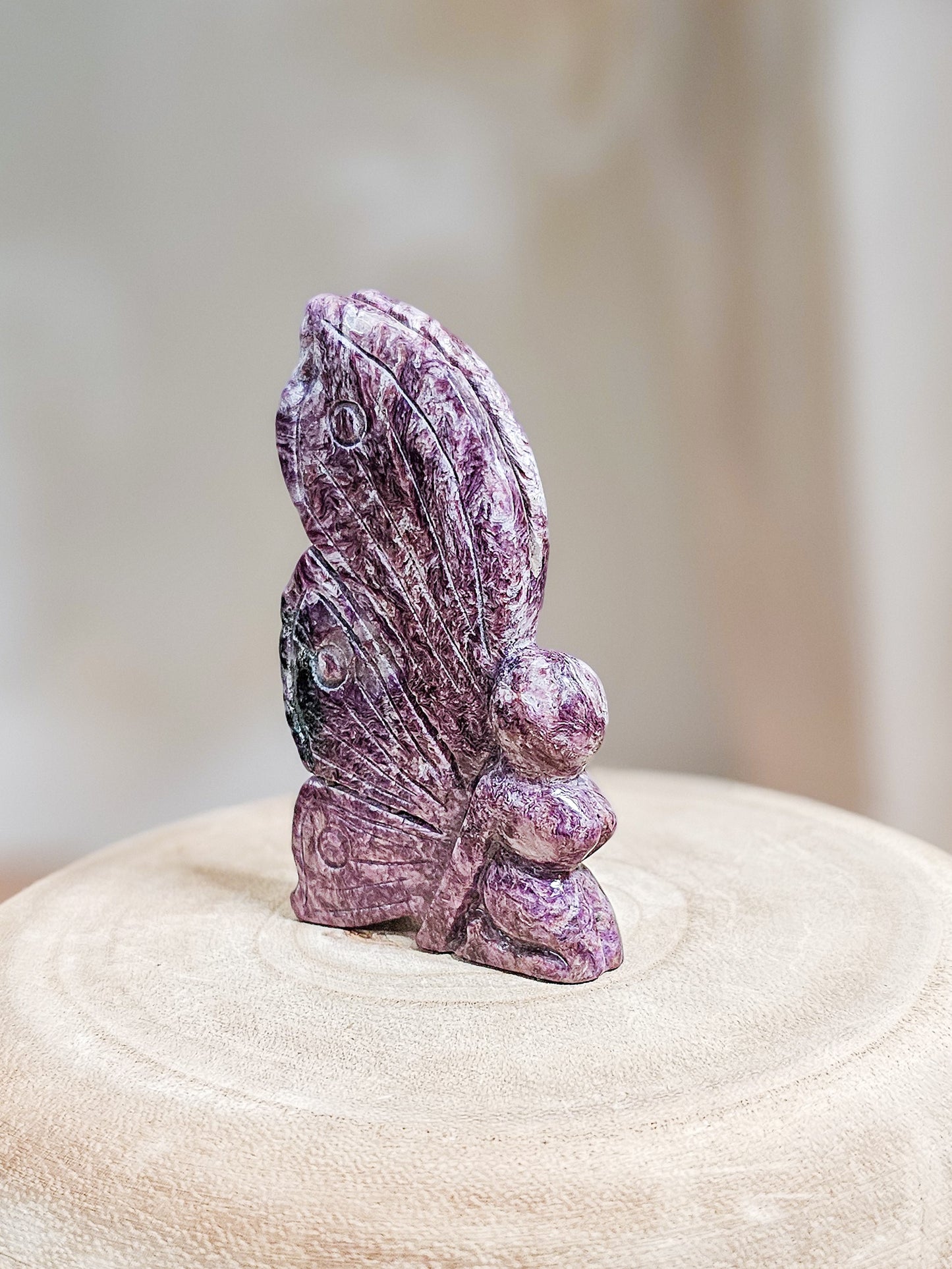 Lavender Charoite fairy carving with smooth polished surface, showcasing natural chatoyant patterns