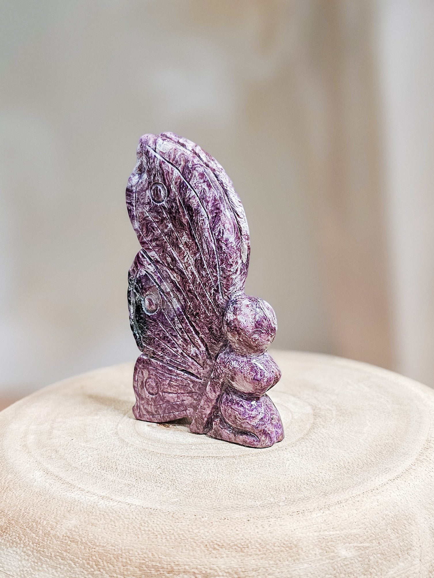 Lavender Charoite fairy carving with smooth polished surface, showcasing natural chatoyant patterns