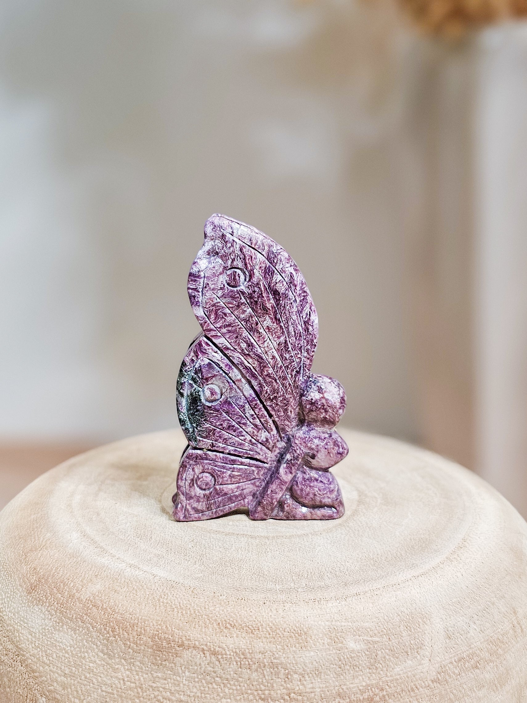 Charoite fairy crystal carving for altar or meditation, detailed fairy wings and fibrous mineral patterns visible