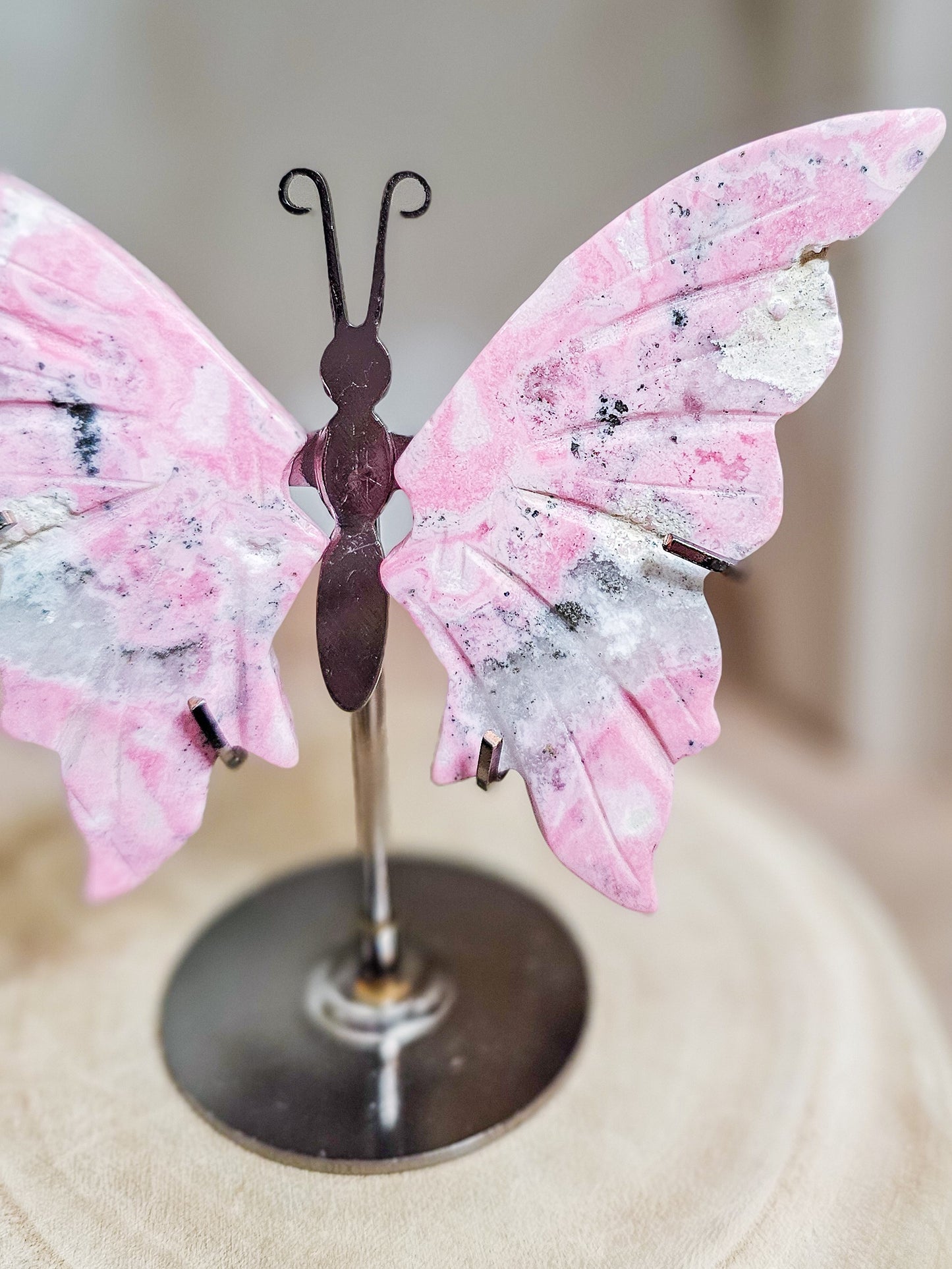 Close-up of Rhodonite butterfly wings, highlighting heart-centred pink colour and mineral veining