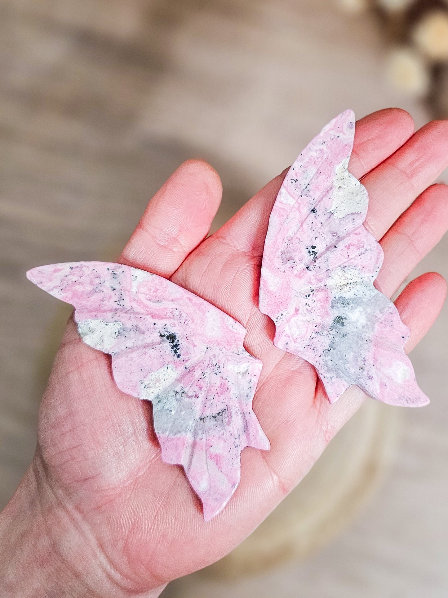 Close-up of Rhodonite butterfly wings, highlighting heart-centred pink colour and mineral veining