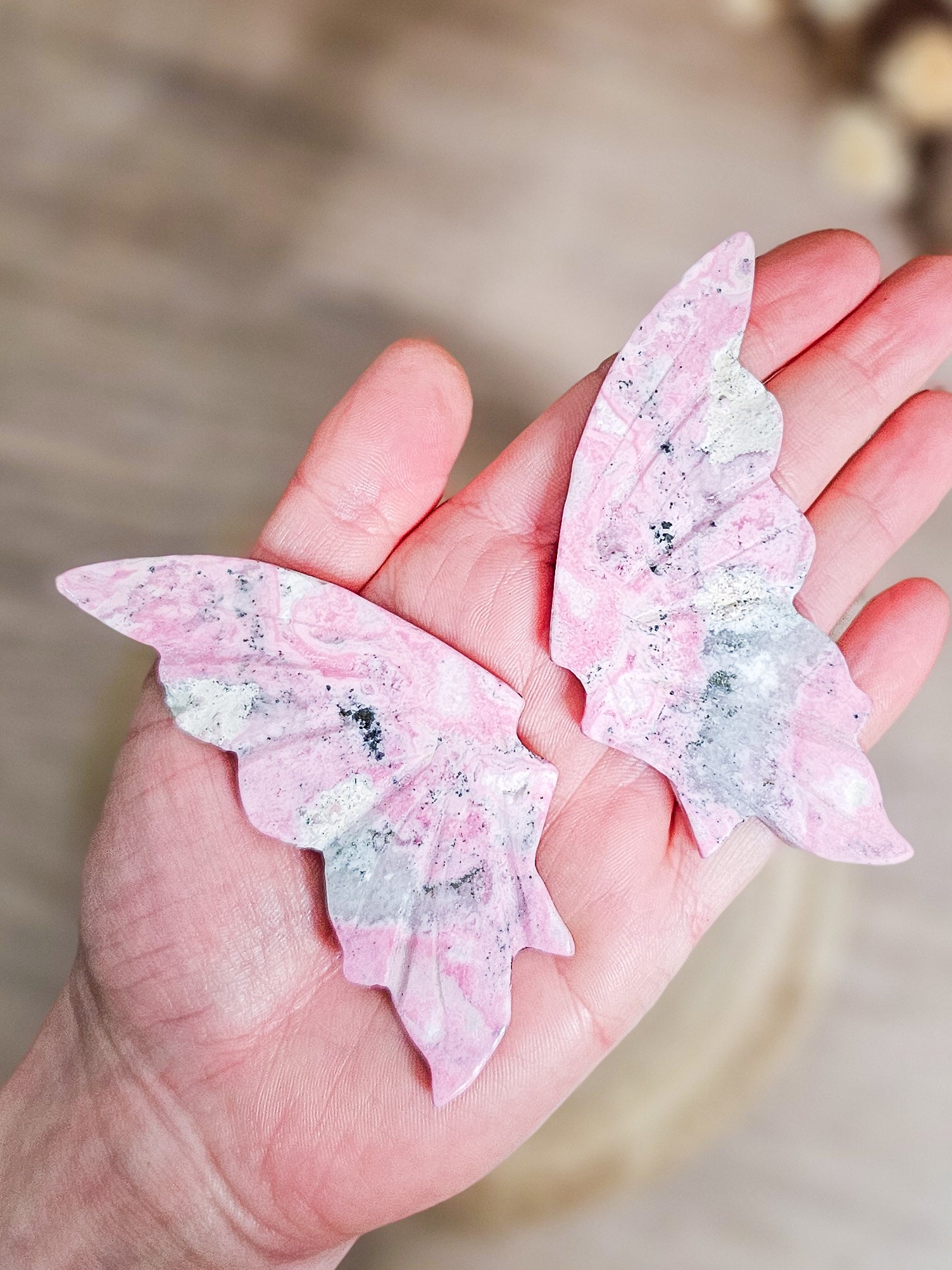 Close-up of Rhodonite butterfly wings, highlighting heart-centred pink colour and mineral veining