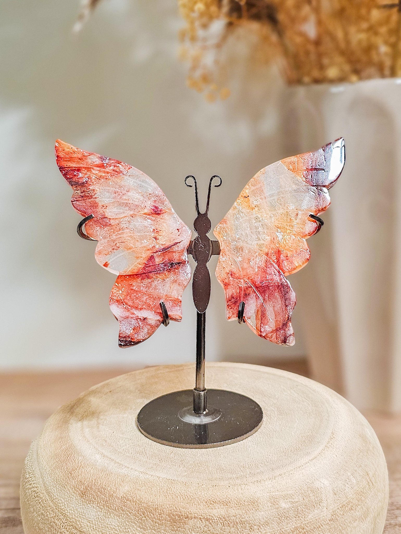 Close-up of fire quartz butterfly wings, highlighting fiery internal patterns and polished crystal surface
