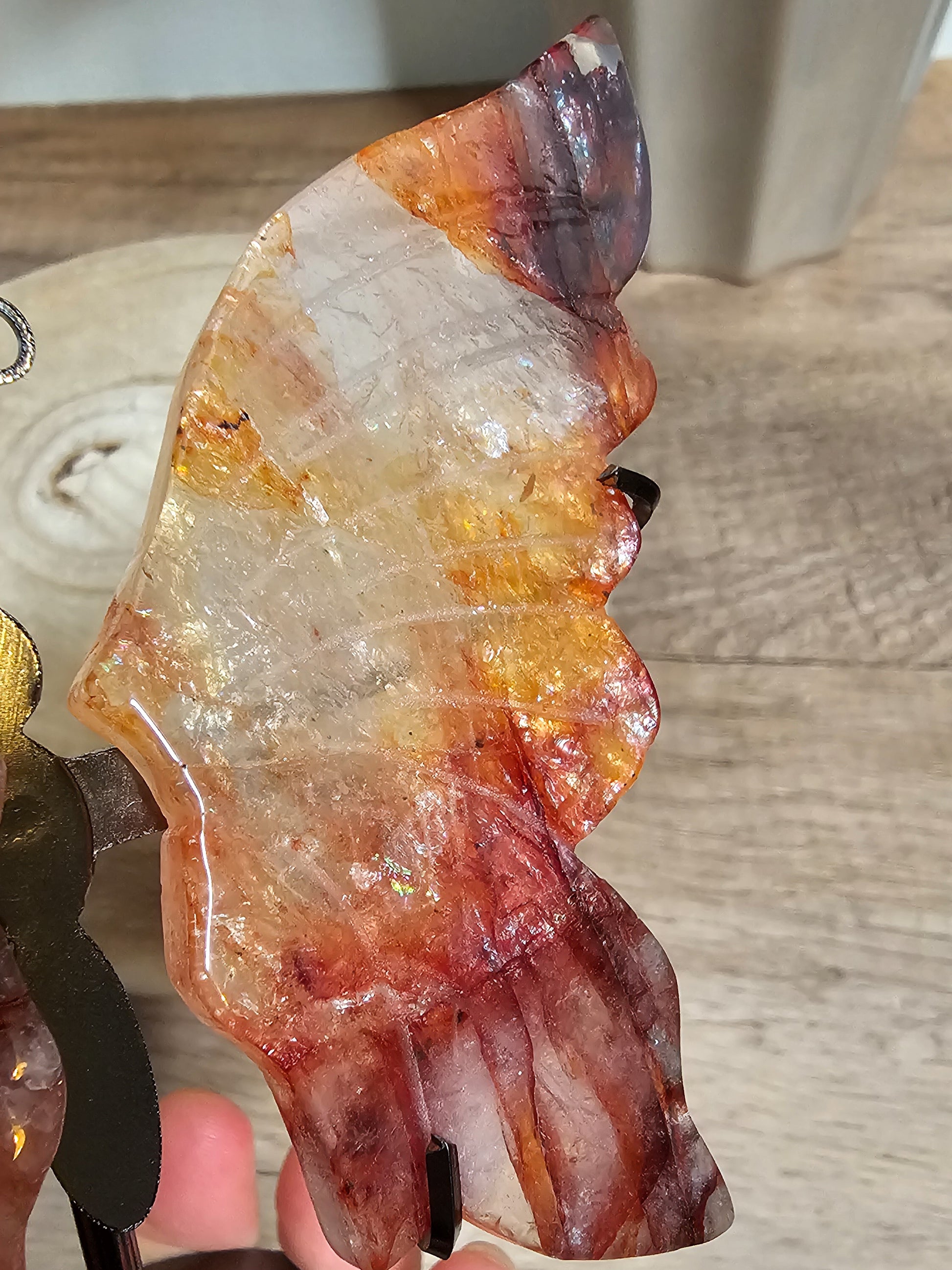 Polished crystal with multicolored patterns on a wooden surface