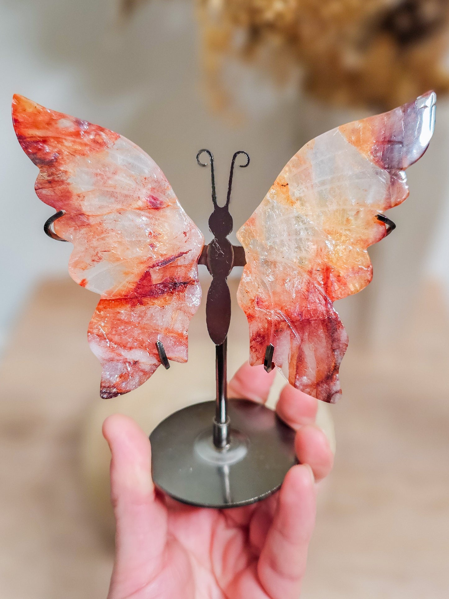 Close-up of fire quartz butterfly wings, highlighting fiery internal patterns and polished crystal surface
