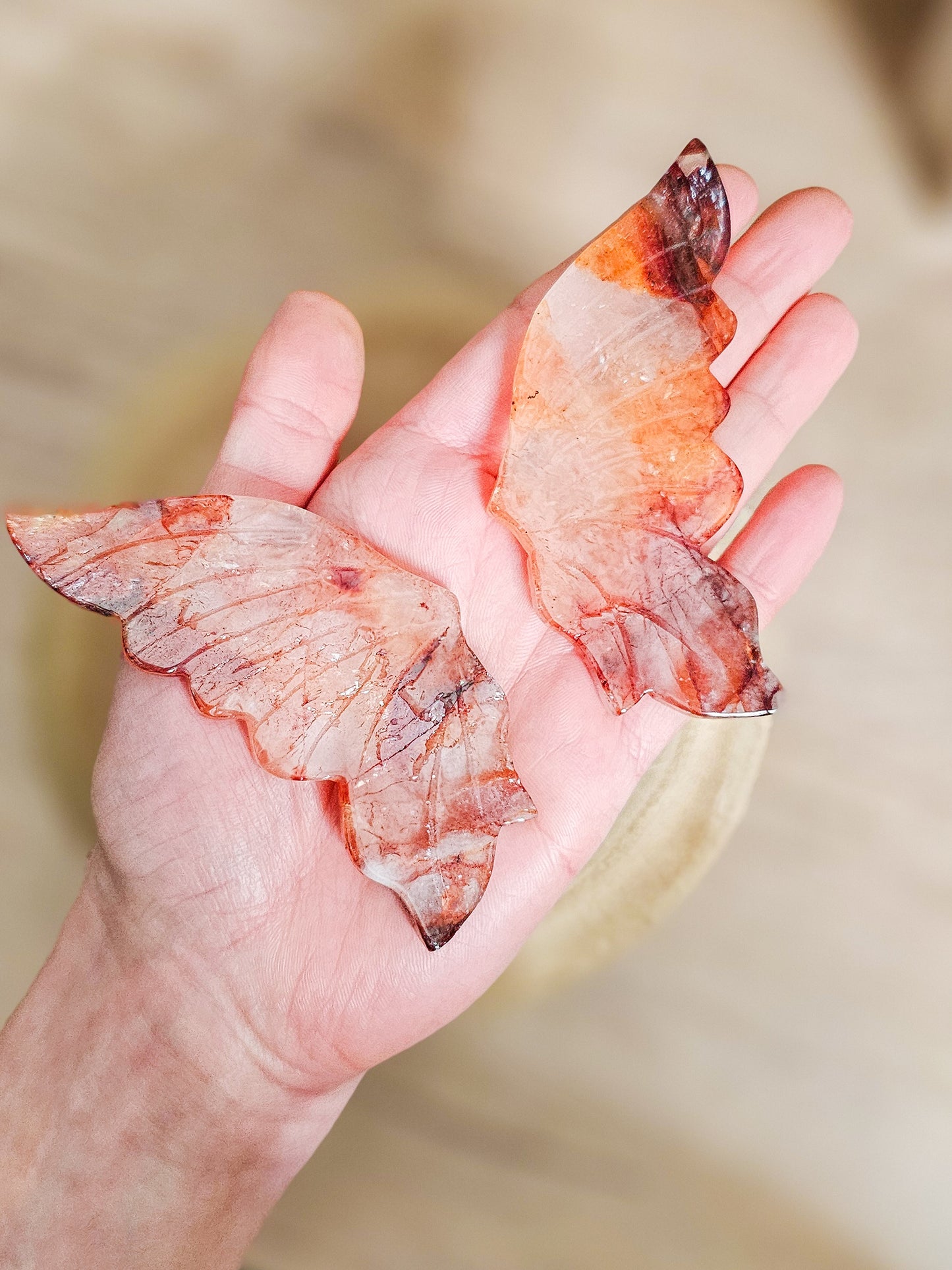 Close-up of fire quartz butterfly wings, highlighting fiery internal patterns and polished crystal surface