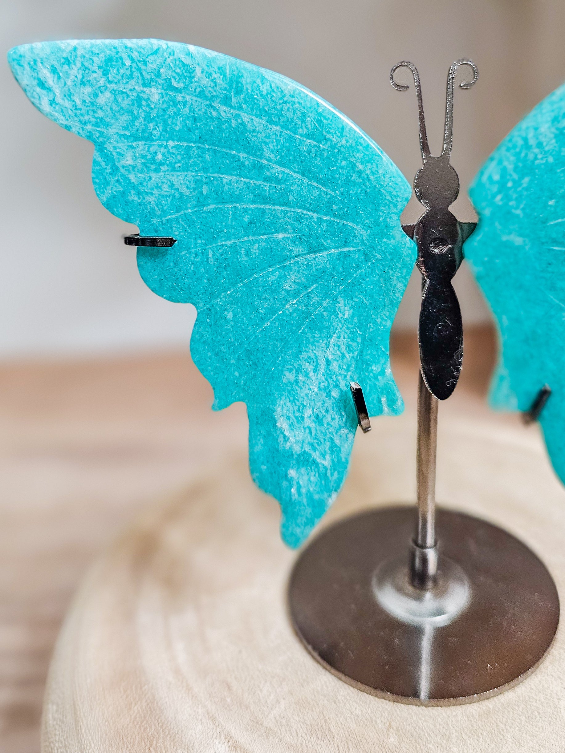 Close-up of amazonite butterfly wings, highlighting blue green colour and polished crystal texture