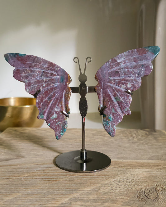 Jasper butterfly wings on a black metal stand, showing natural mauve, pink, green, turquoise and white patterns.