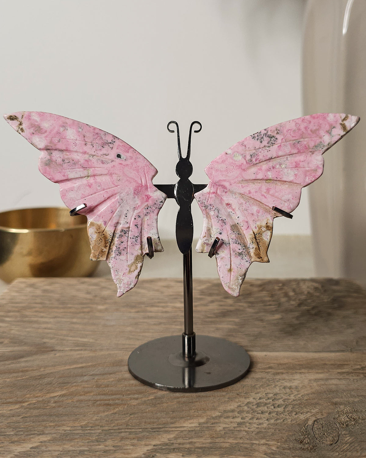 Peruvian Rhodonite crystal butterfly wings on a metal stand, with unique pink and dark markings. A meaningful gift or addition to your crystal collection.