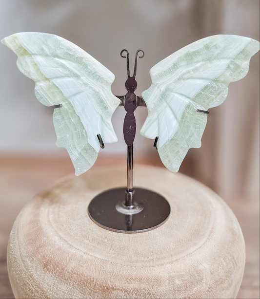 Pistachio Calcite butterfly wings on stand, carved green calcite with soft translucent tones and delicate wing shape