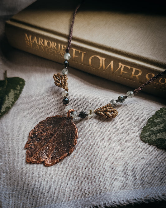 Scottish Botanical Amulet Nettle Spirit featuring a real copper electroformed dead nettle leaf with Prehnite and Epidote beads and handwoven micromacramé detailing.