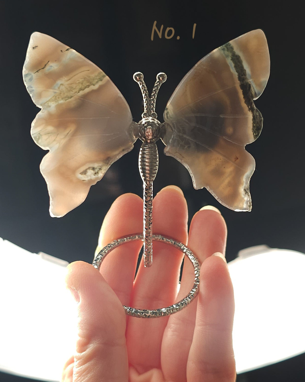 Moss Agate crystal butterfly wings on a stand with natural green moss-like inclusions. A nature-inspired decorative piece and meaningful gift for new beginnings.