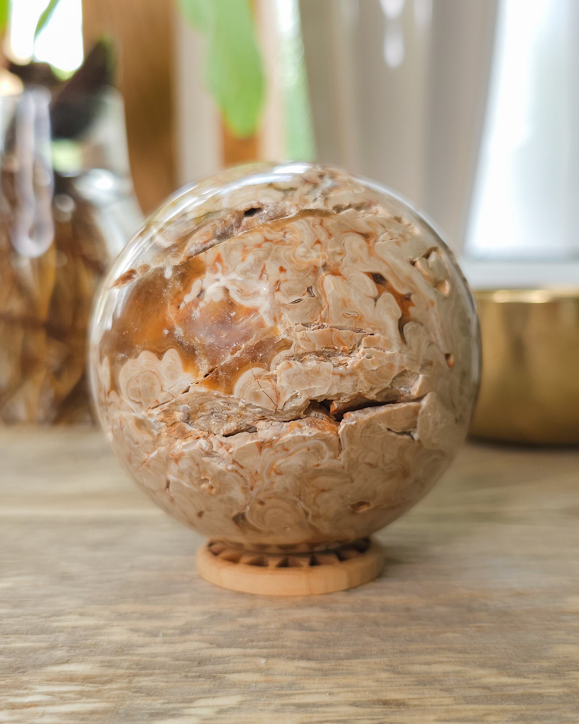 Chocolate Calcite sphere displaying crystal-filled opening and natural brown, cream and honey coloured bands.